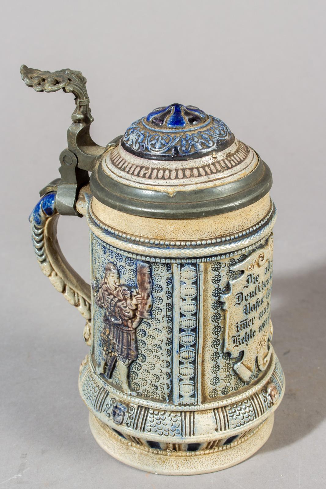 Stoneware 1/2l beer stein with an original pewter hinged lid. The body is decorated with a player, original craquelure.
Made in Germany, circa 1890.