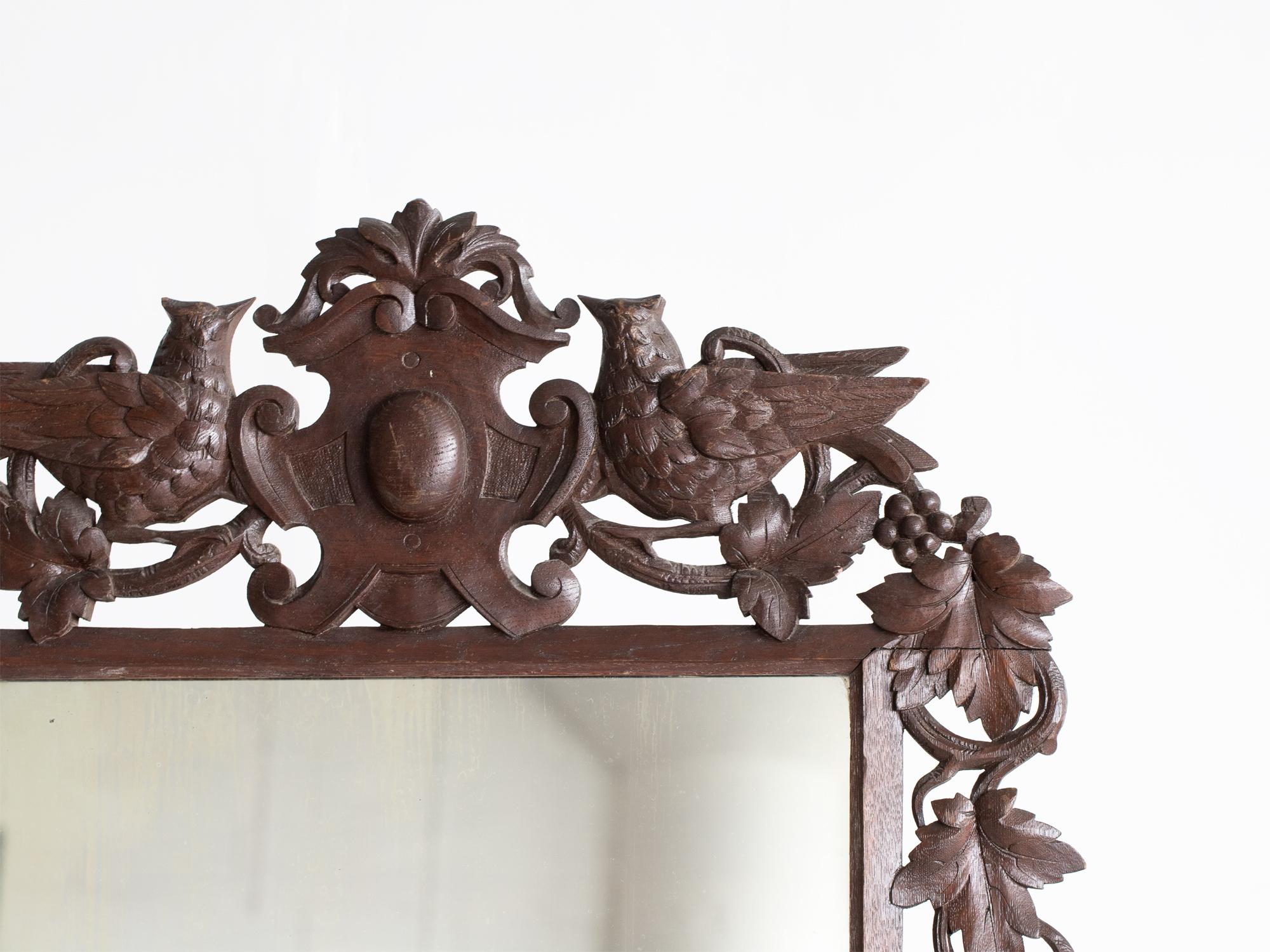 A large Black Forest overmantle or wall mirror. Germany, 19C.

Patinated oak frame with opposing cuckoos and foliate carvings, retaining its original plate.

110 x 74 cm

43.3 x 29.1 “