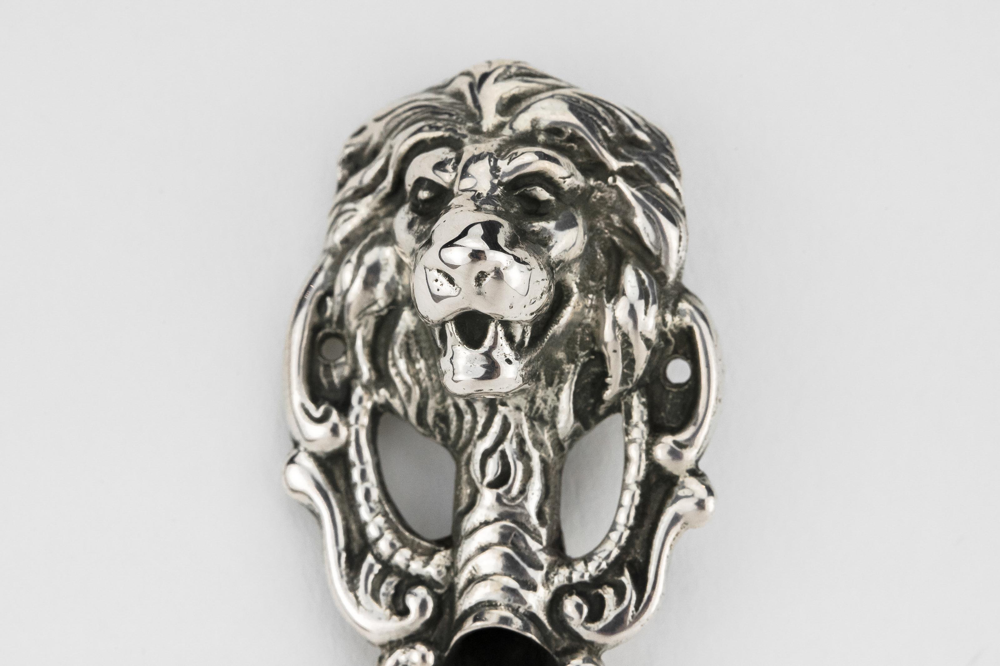 Silver Mezuzah by Adolf Mayer, Germany, circa 1890.
Decorated with a bolt lion head on the top, skin fish design on the midsection, and flowers at the bottom. Marked on the back with German silver hallmarks and with the maker's mark.

The Mezuzah