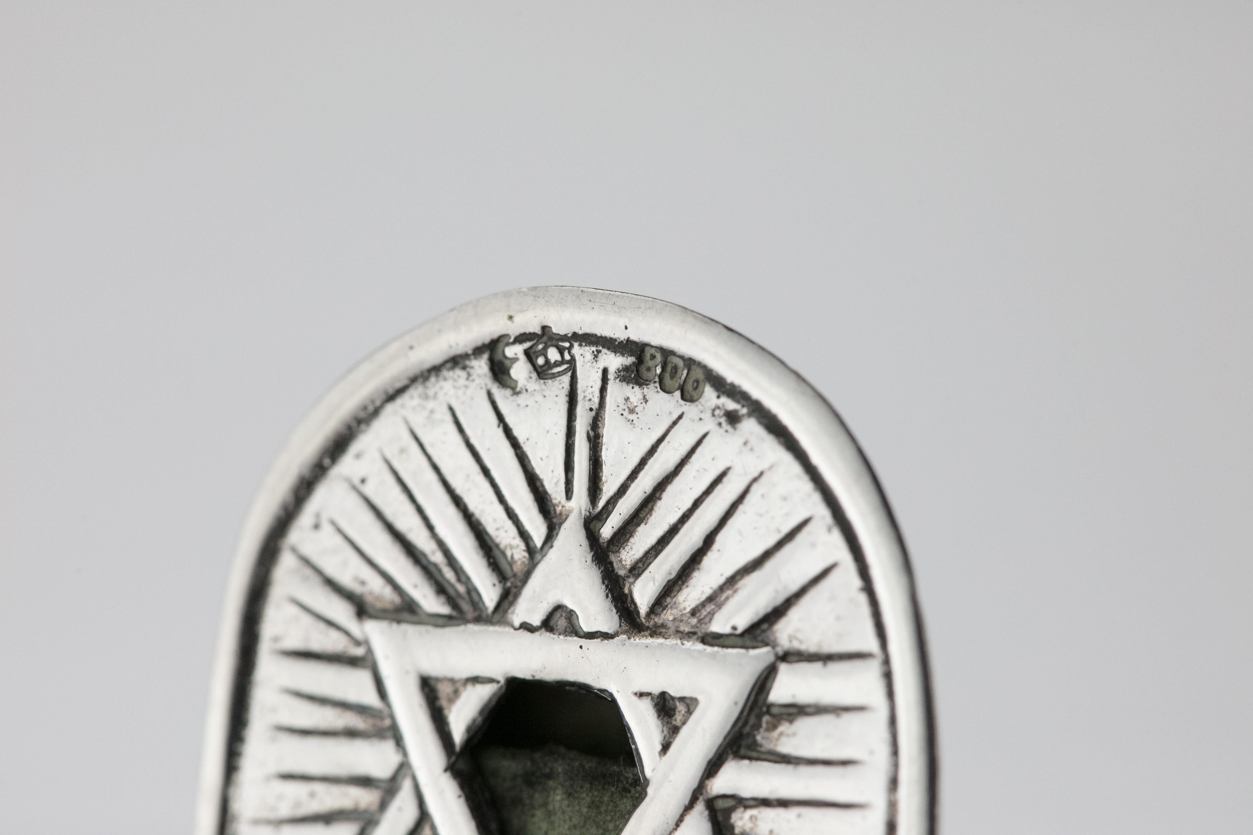 Fine antique silver Mezuzah, Germany, circa 1890.
Decorated with a Star of David on the top, foliage design on the midsection, and the rising sun at the bottom. Marked on the back with German silver hallmarks and with the maker's mark.

The