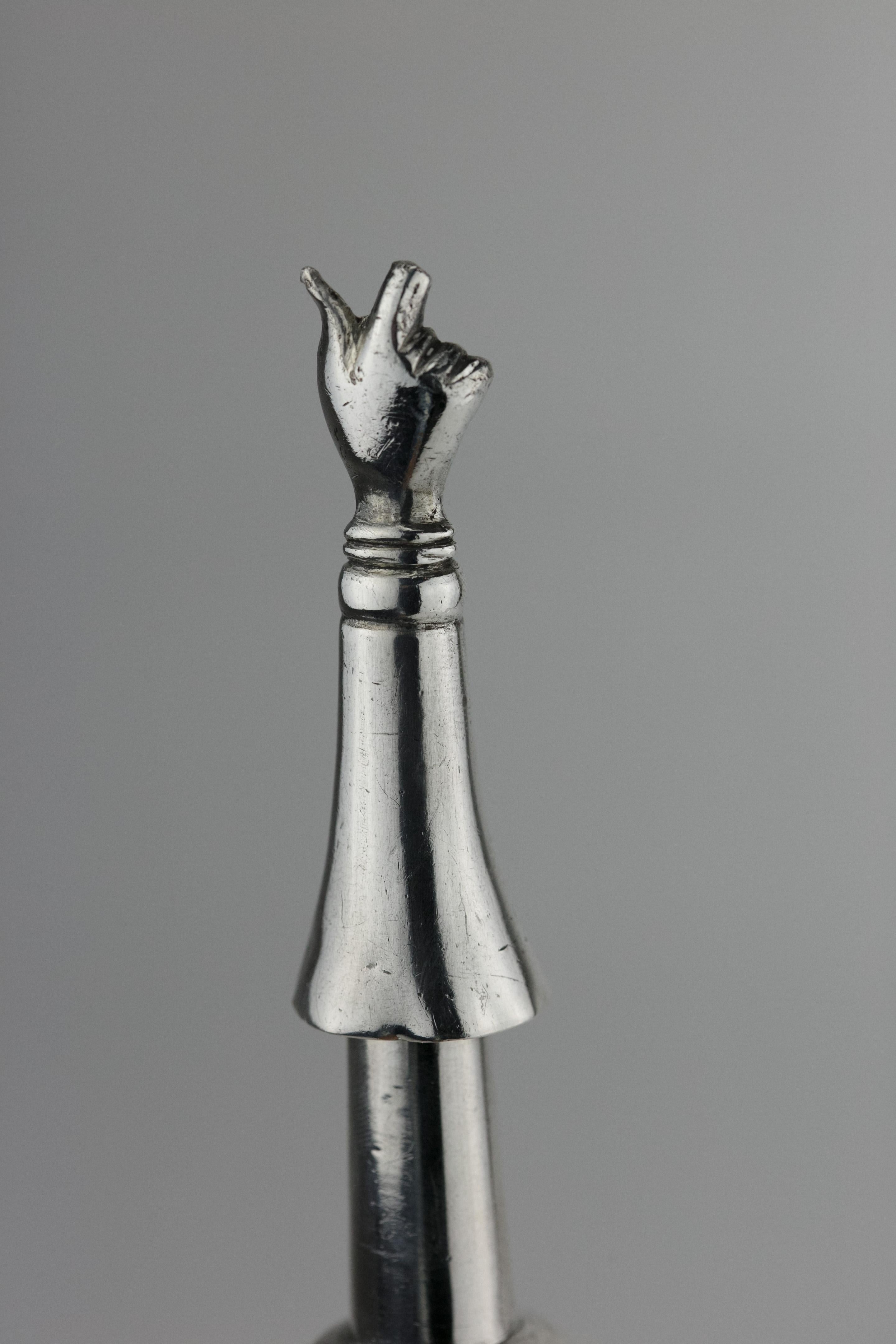 Handmade silver Torah pointer, Russia, circa 1880.
The handle is made with a knob shape interval engraved with floral ornaments.
The reading end is shaped as a hand with a pointing index finger. A suspension loop is connected to the top of upper