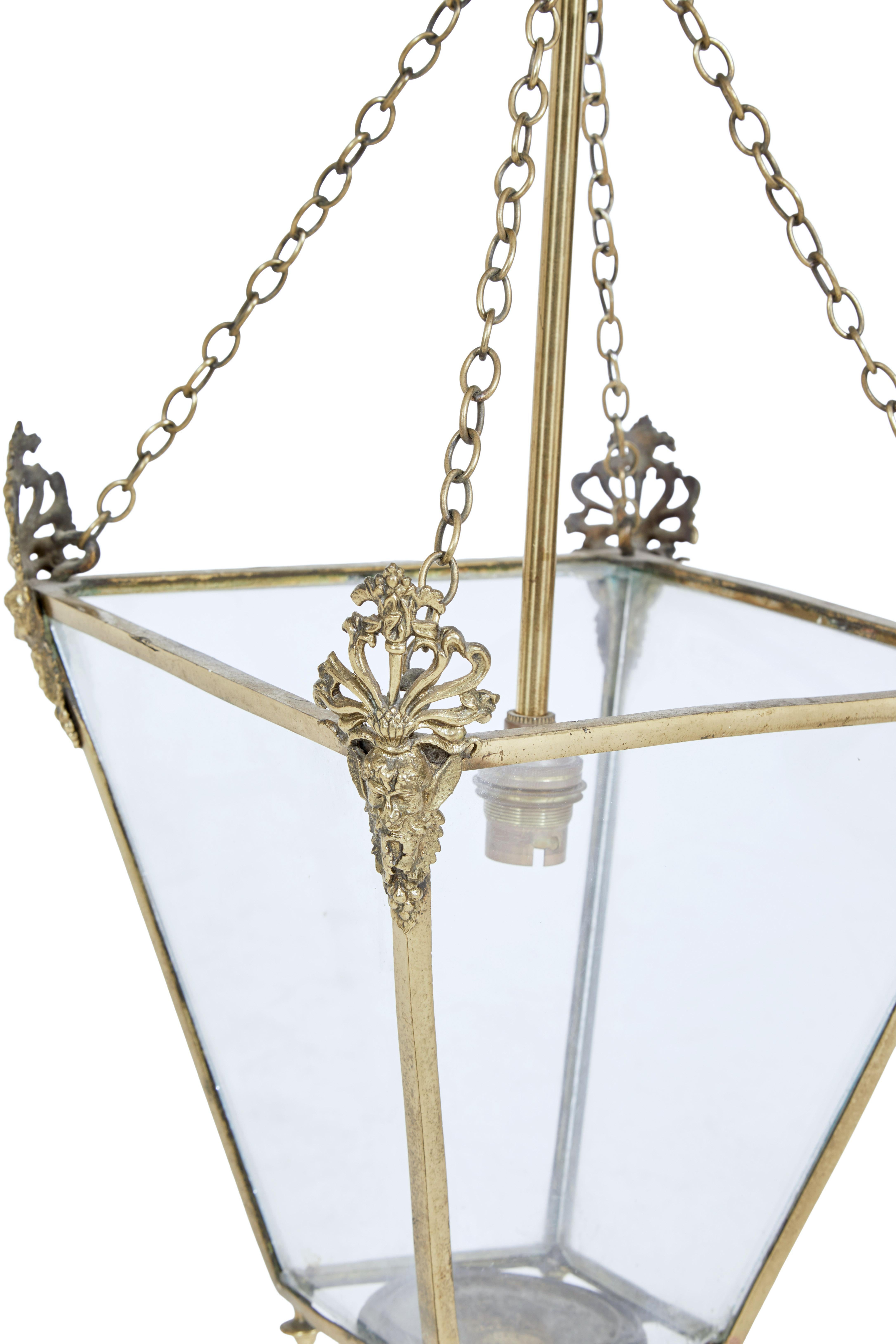 Late 19th century gilded and glazed hanging lantern circa 1890.

Fine quality gilded 4 sided lantern with elaborate cast grotesques on each corner. Further decorated with finials on the bottom.

Supported by 4 chains that lead to a central rose.