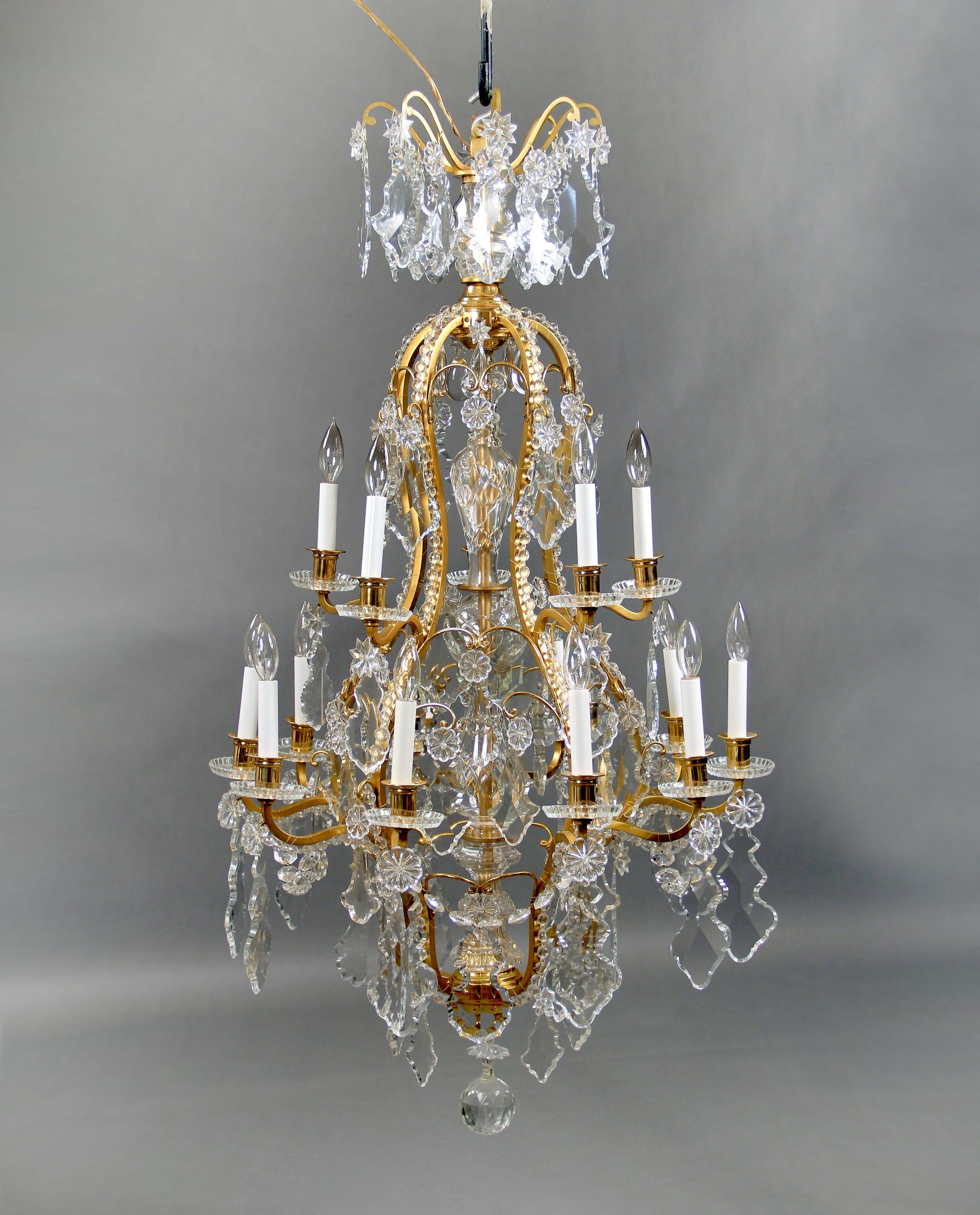 A stunning late 19th century gilt bronze and Baccarat crystal fifteen-light chandelier

Multi-faceted and shaped crystal, cut crystal central column, beaded frame. Fifteen tiered perimeter lights, bobeche cups.

