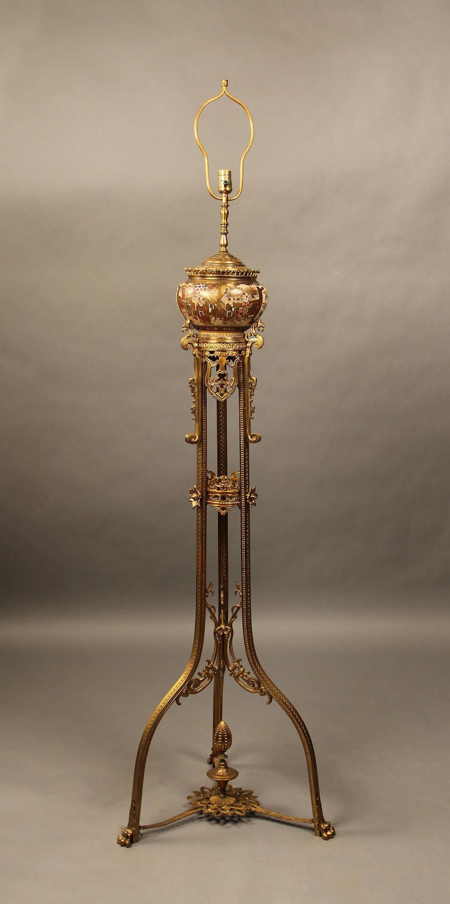 Late 19th Century Gilt Bronze and Japanese Satsuma Porcelain Floor Lamp

The round lamp with painted scenes of men, women and children in landscape scenes and at leisure surrounded by very fine raised gold designs, sitting on a nicely designed