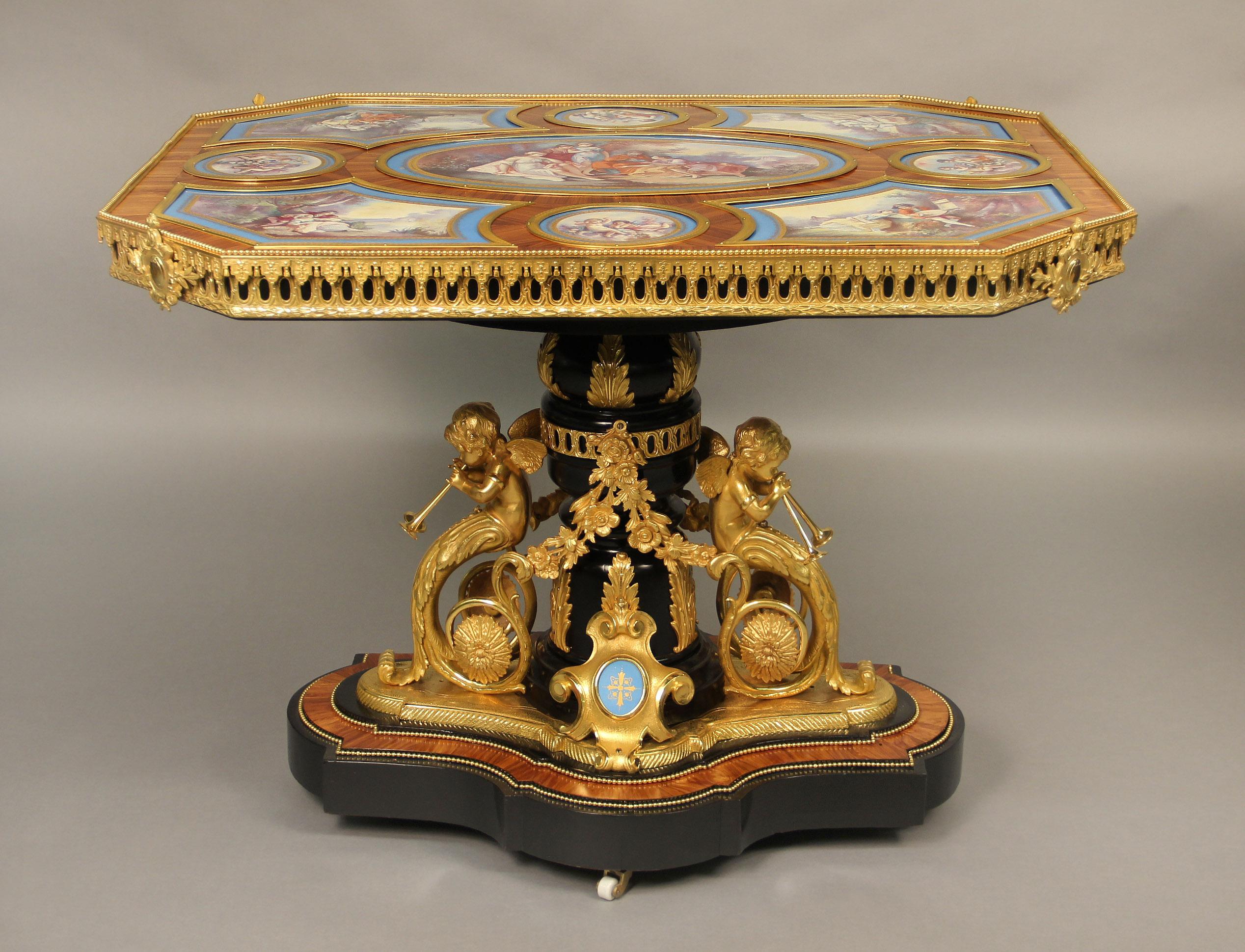 An Excellent Late 19th century Gilt-Bronze and Sèvres Style Porcelain Mounted Kingwood and Ebonized Wood Center Table.

The rectangular shaped table with nine individual turquoise painted porcelain plaques, the large oval center plaque depicting a