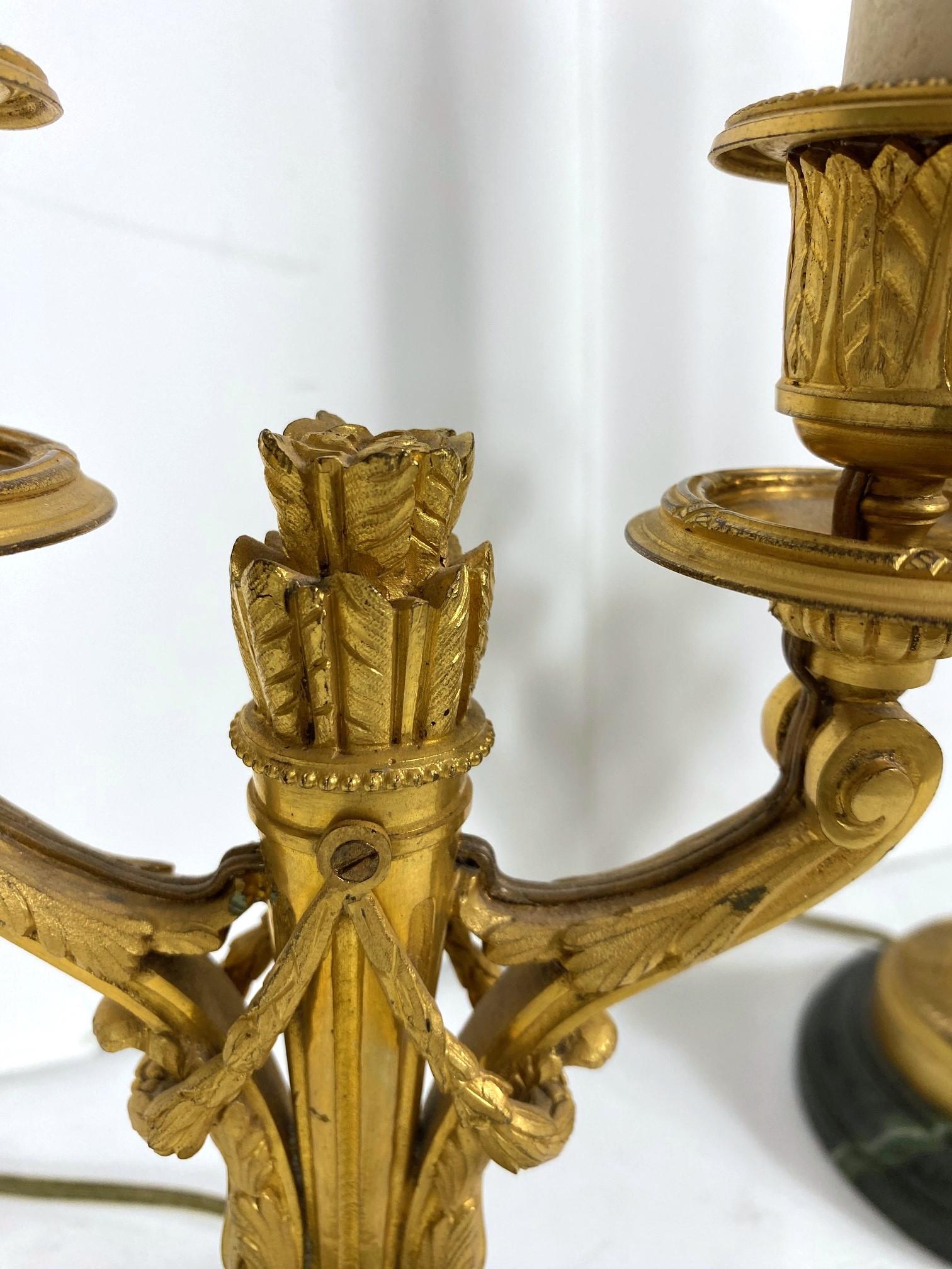 A set of two French gilt bronze bouillottes lamps. The base is faux-marble and wire for the USA. Measurements without shade: 14