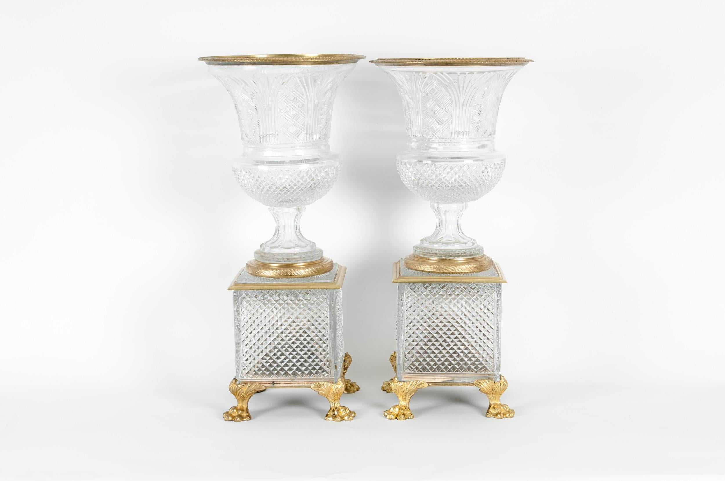 Late 19th century gilt bronze mounted / cut glass with square footed base pair decorative vase / centerpiece. Each urn / vase is in good antique condition with wear appropriate to age / use. One of the urn is glued to the base . Each one measure