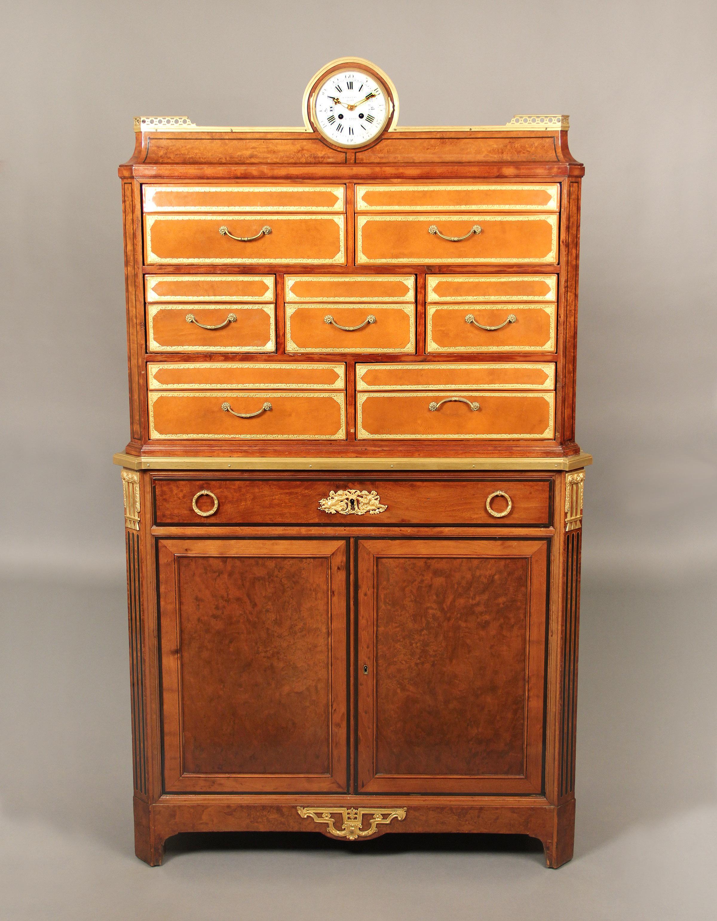 A rare late 19th century Louis XVI style gilt bronze-mounted cartonnier or secretaire

By Antoine Krieger

The upper section containing seven deep tooled leather veneer drawers, above a concave frieze surmounted by a three-quarter gallery and