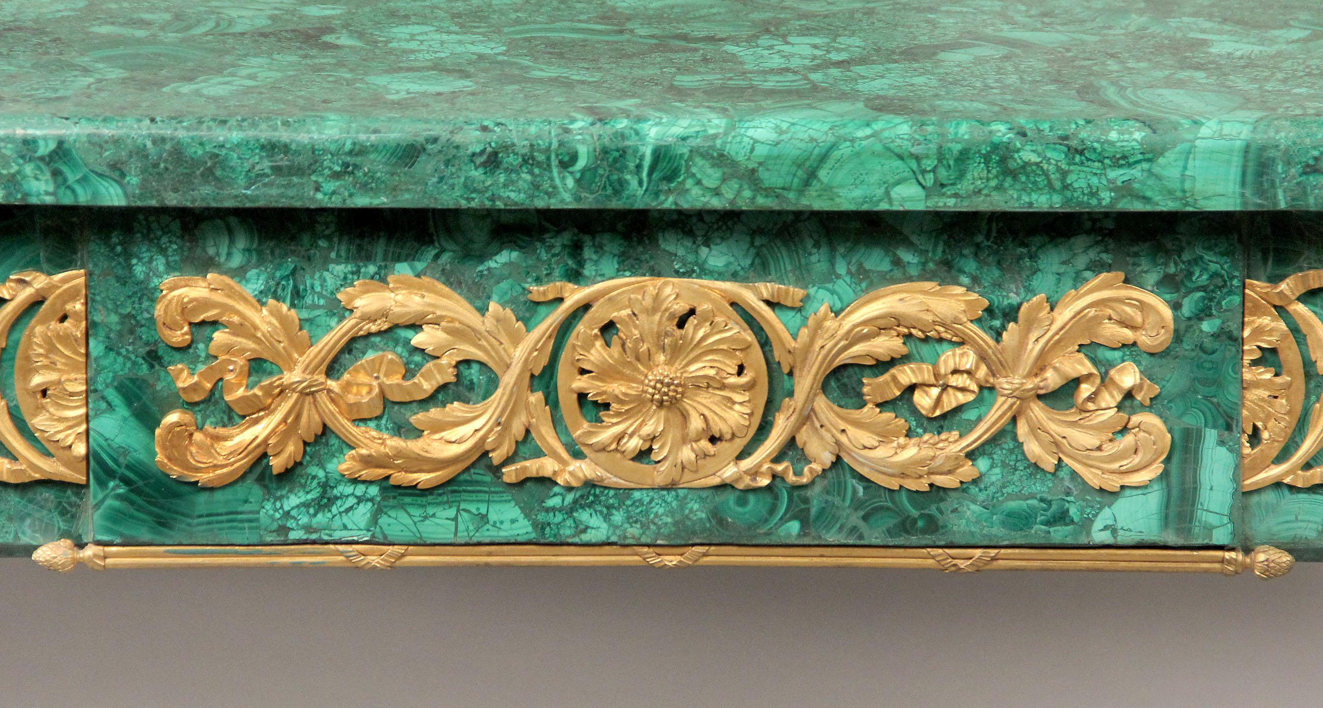 A nice quality late 19th century gilt bronze mounted Louis XV Style malachite center table

Decorative malachite top above bronze frieze, bronze-mounted tapering legs sitting on lion paw feet.

Malachite is a semi-precious stone and also a