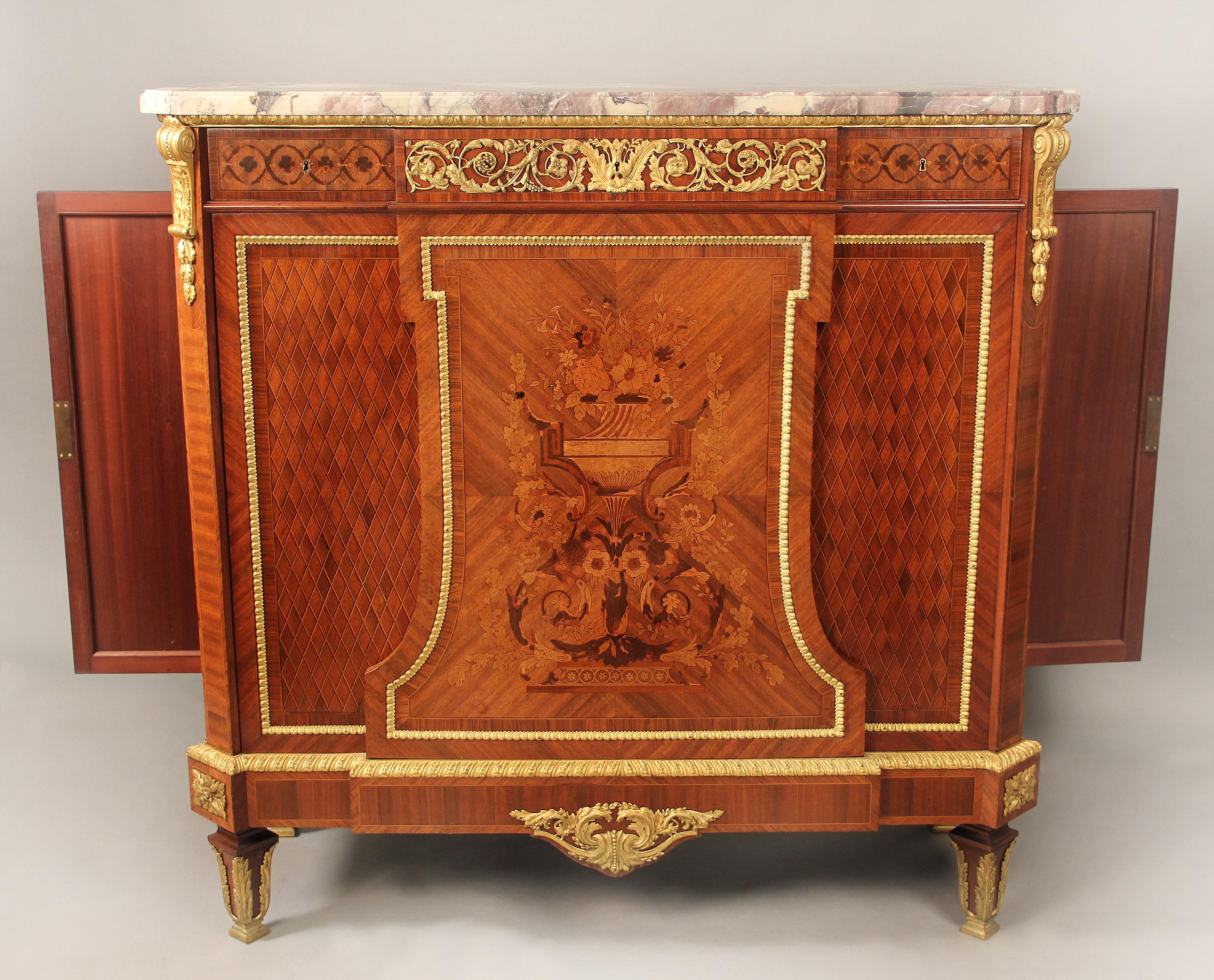 A wonderful Late 19th century Louis XVI style gilt bronze mounted marquetry and parquetry cabinet by Maison Forest, Paris

Maison Forest

The breche violette marble top above a center frieze drawer designed with bronze mounts of flowers and