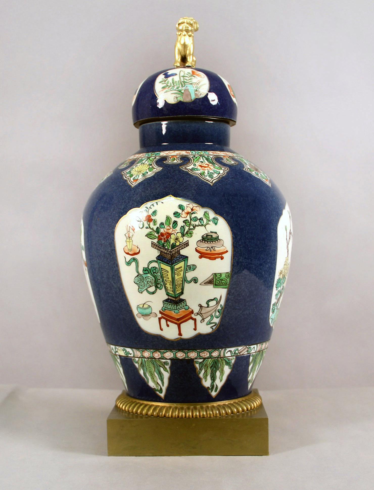A Late 19th Century Gilt Bronze Mounted Samson Porcelain Oriental Decorative Vase


The blue vase hand painted with four floral and interior scenes, the top and bottom decorated with a band of flowers and foliage, the top headed by a foo dog and