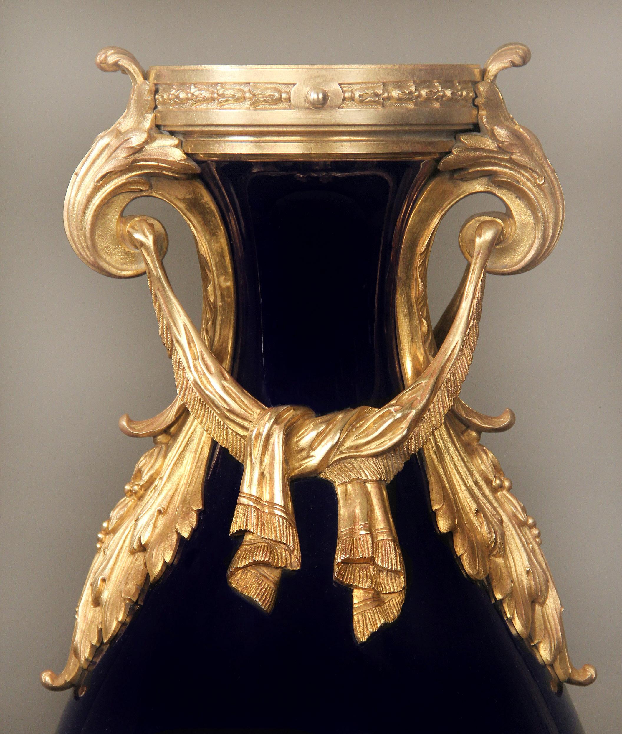 Late 19th century gilt bronze mounted Sèvres style porcelain vase.

The cobalt blue vase mounted with tied bronze drapes and handles. 

In late 1739-early 1740 the Sèvres Porcelain Factory opened in the Royal Château of Vincennes, Sixteen years