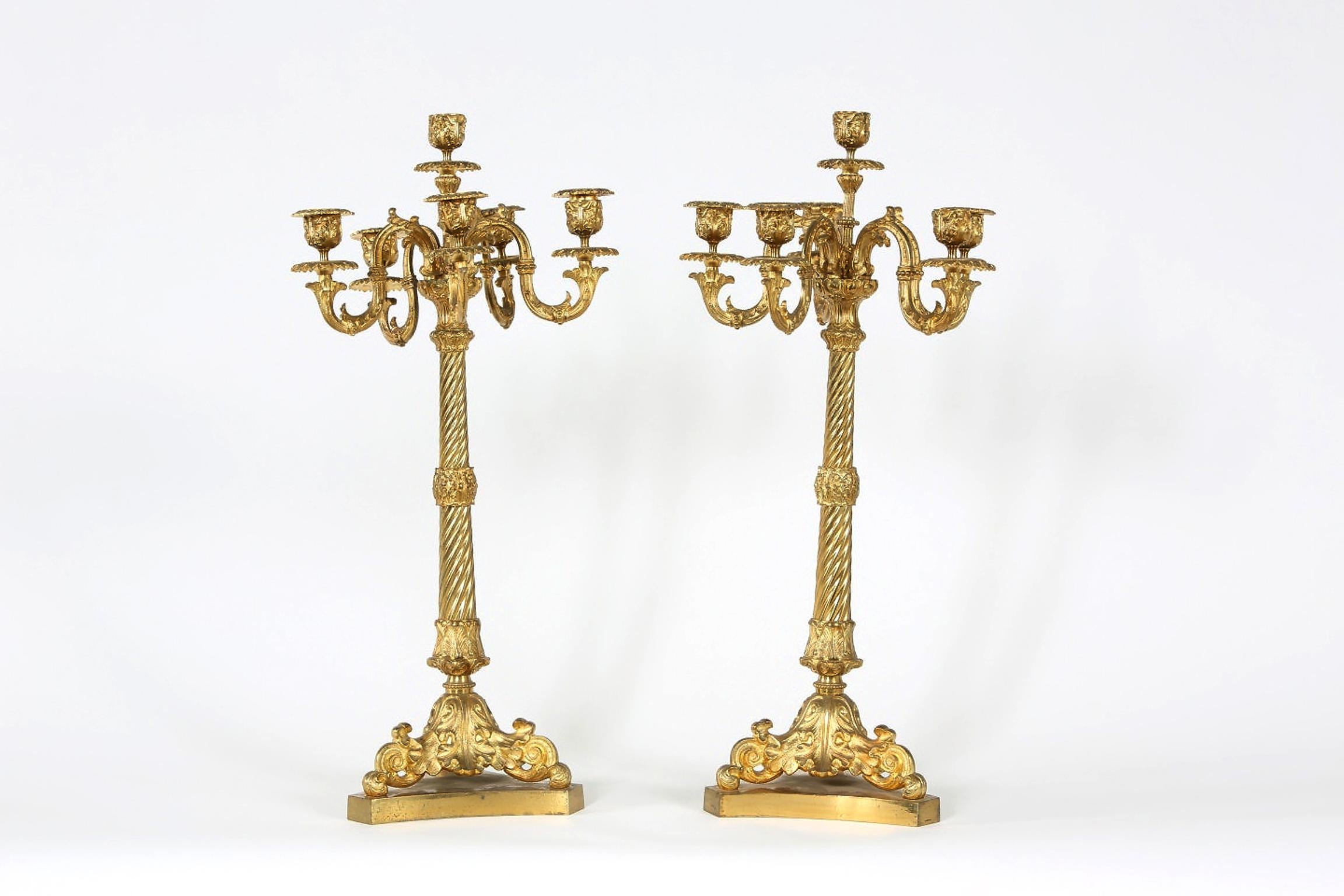 Late 19th century gilt bronze six arms candelabras with exterior design details. Each candelabras measure about 22.5 inches tall x 6.5 inches x 6.5 inches base. Each candelabras has only four bobeche. Very good condition for age with appropriate