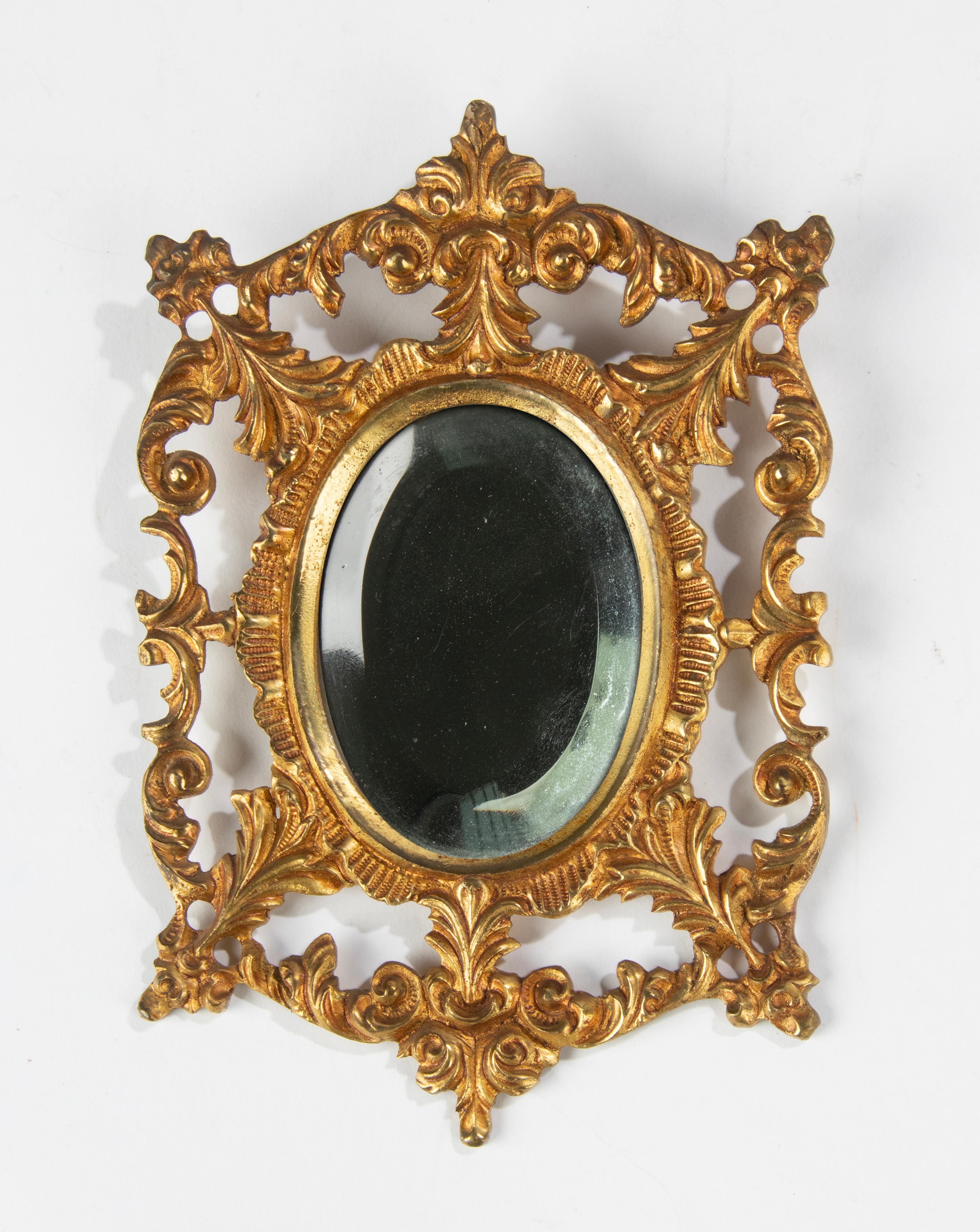 A little antique bronze wall mirror, with a beveled mirror glass. The bronze frame has a cold-gilt patina. Made ink France, circa 1890-1900
Dimensions: 17 (h) x 11 x 1 cm.
 