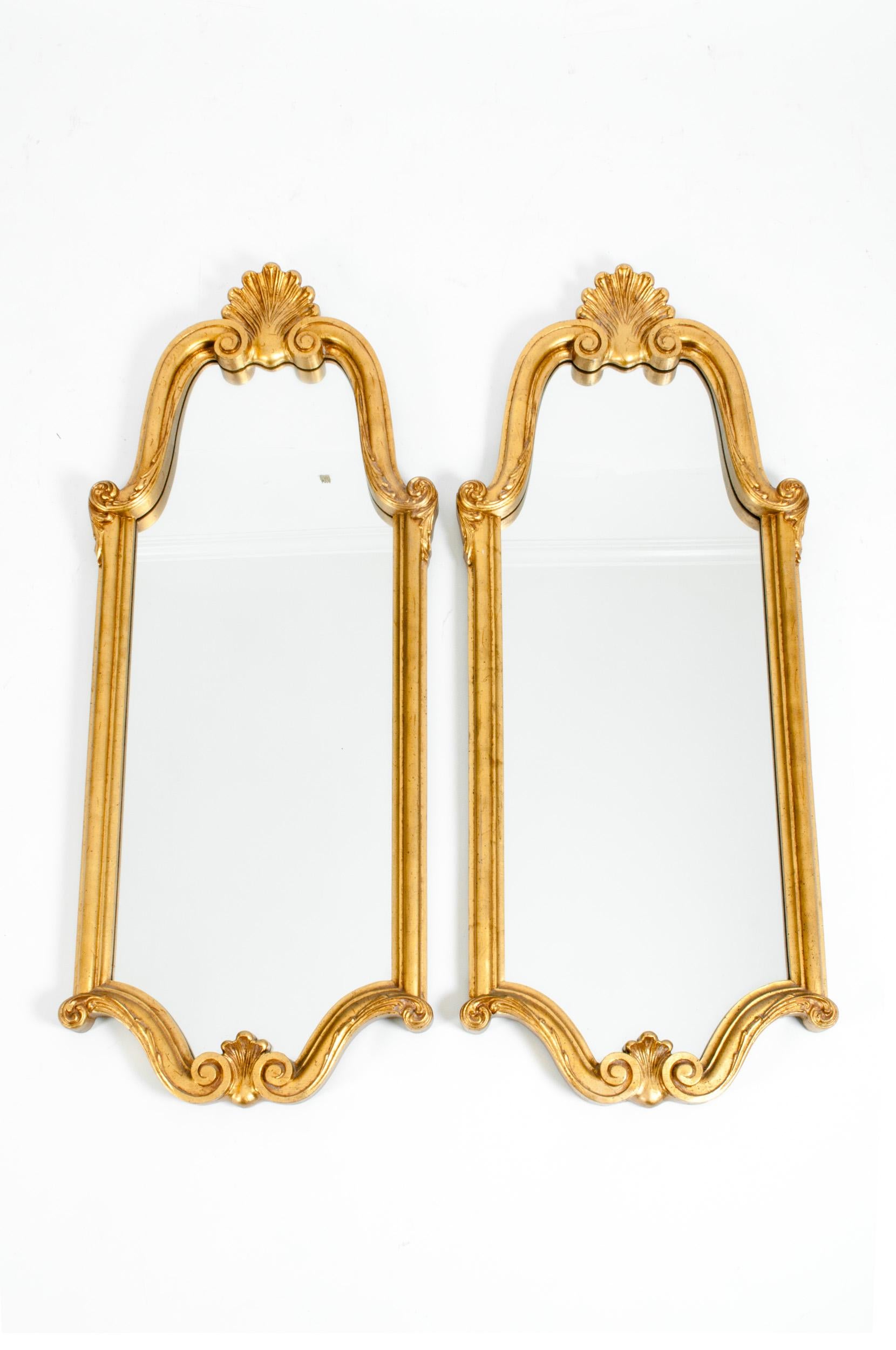 Late 19th century giltwood frame matching pair hanging wall mirror with arched top design details. Each mirror is in great condition with appropriate wear consistent to age / use. Each mirror measure about 48.5 inches length x 19.5 inches wide.