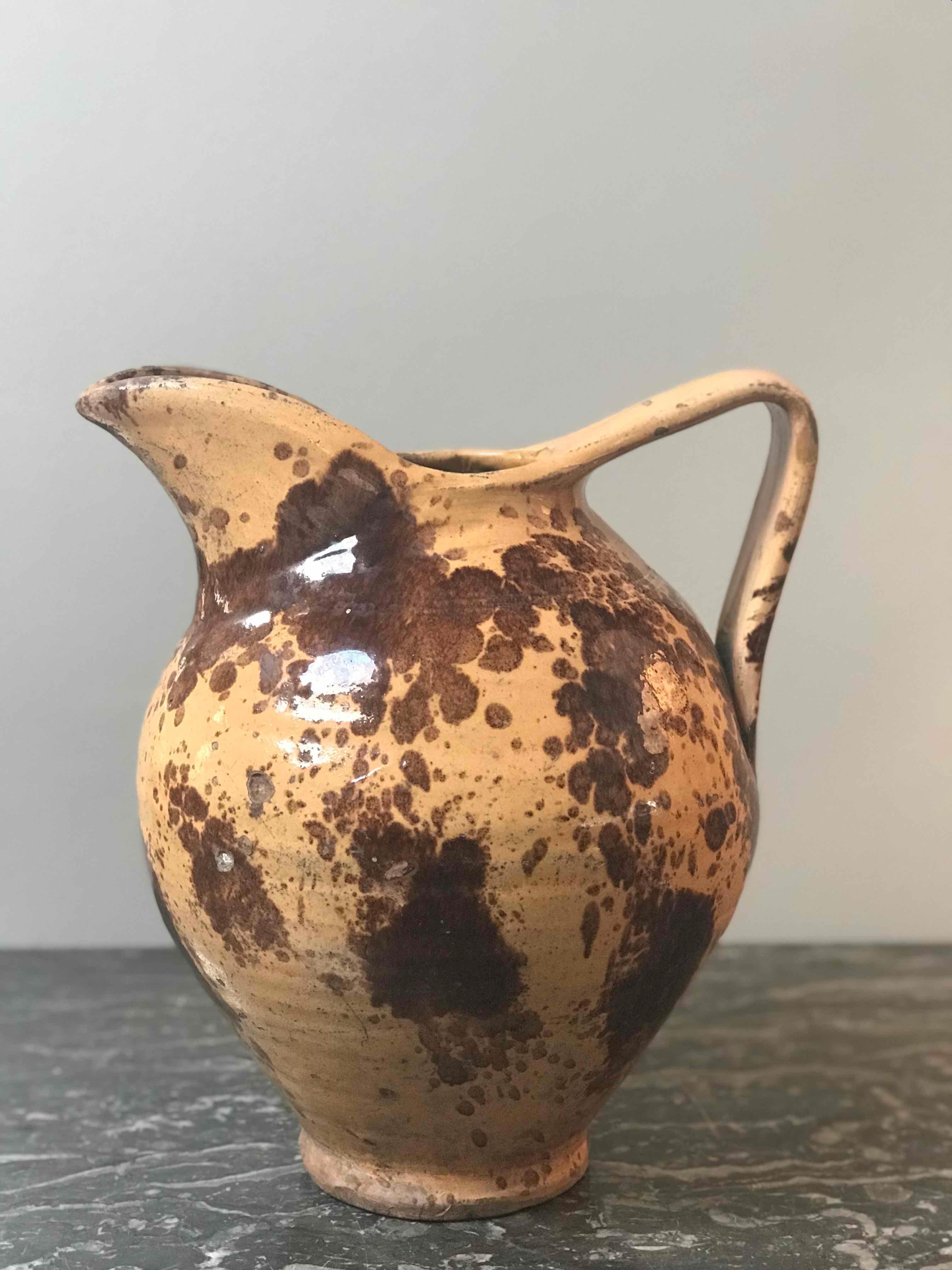 Late 19th century glazed yellow and brown pitcher pot from France. 