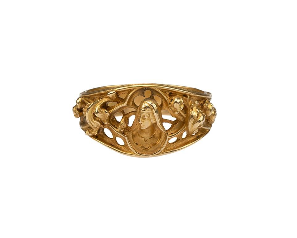 Louis Wièse 
Ring with Head of the Virgin
France (Paris), c. 1890
Gold
Weight 11.5 gr.; Circumference 66.73 mm.; US size 11 3/4; UK size X ¼

The gold band with profiled edging and openwork decoration widens toward the bezel. The shoulders are