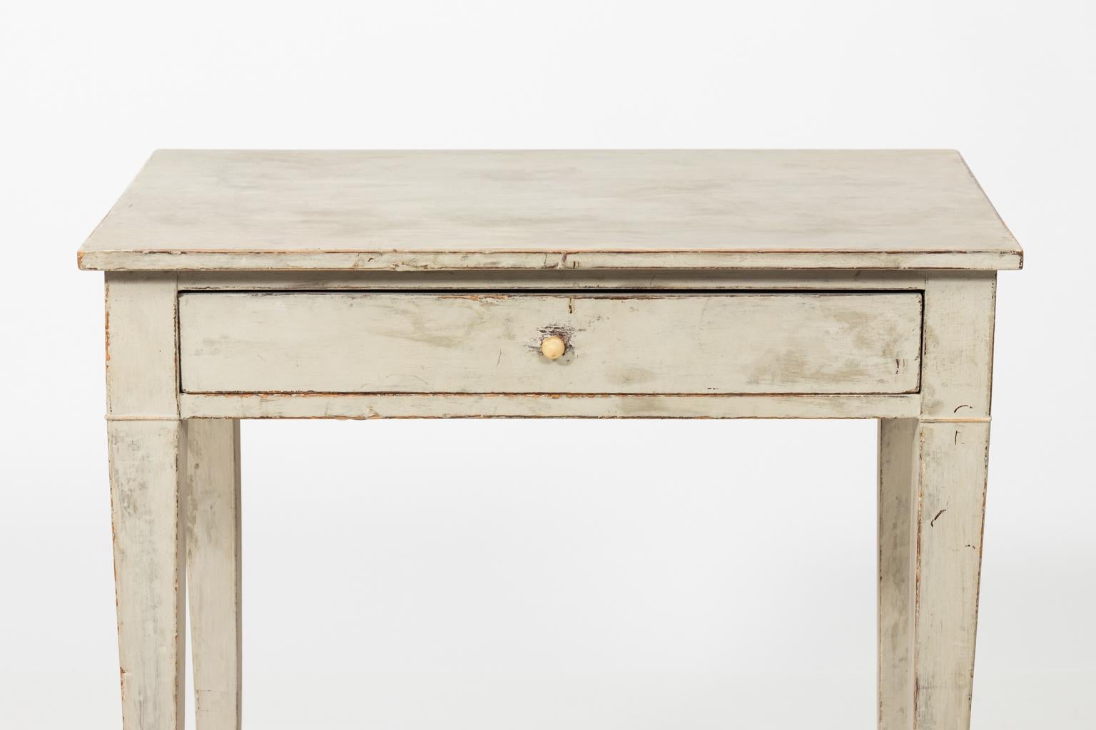 Late 19th century Gustavian antique writing table with one drawer and plain tapered legs.  Please note that on the inside of the back right corner of the drawer there is a minor gap in the joining due to age.
 