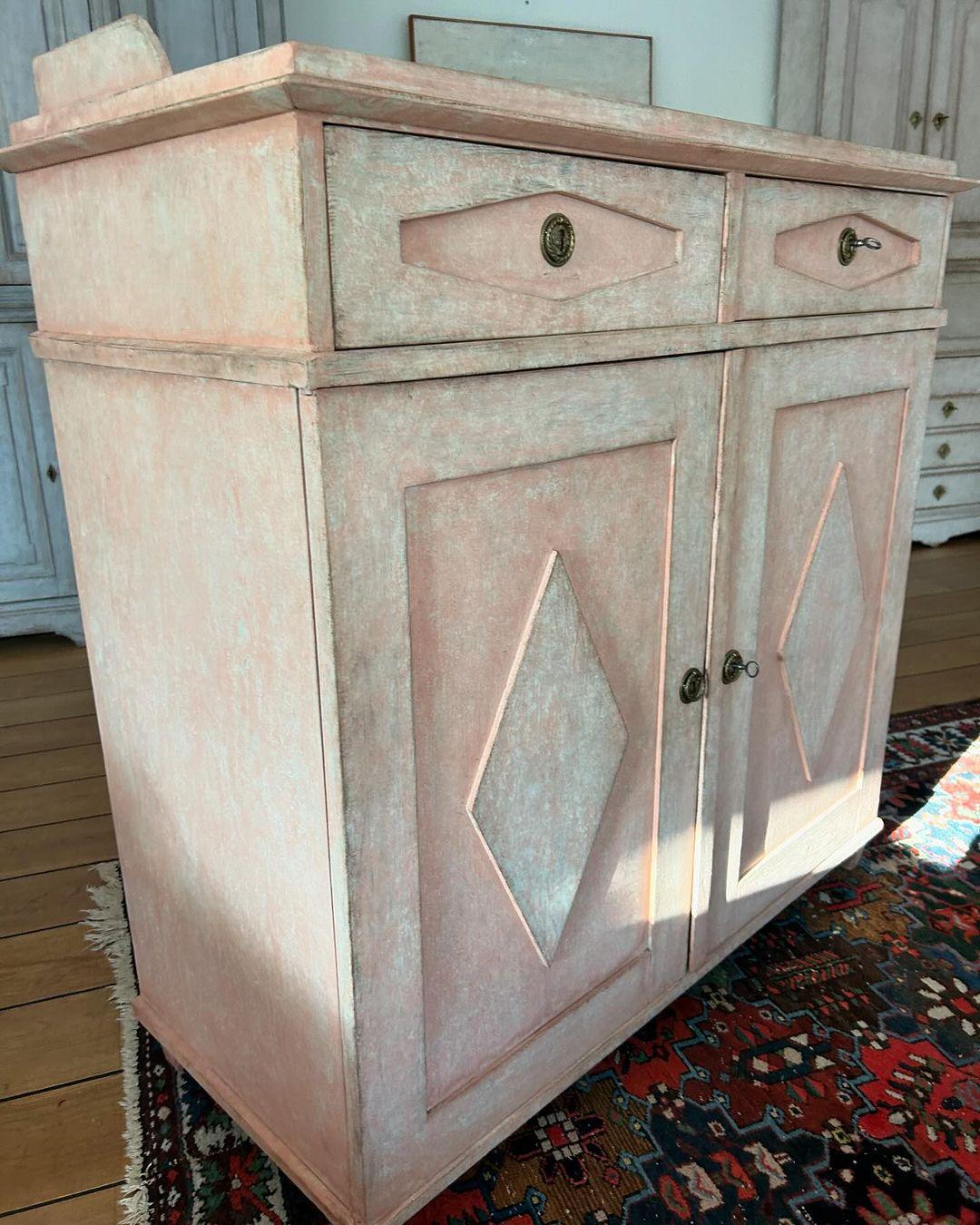 Swedish Gustavian sideboard
The sideboard is painted in pink and the inside in antique white,
Both in an old traditional scandinavian way with fantastic patina.

The sideboard has traditional gustavian decorative diamond panels on cabinet doors and