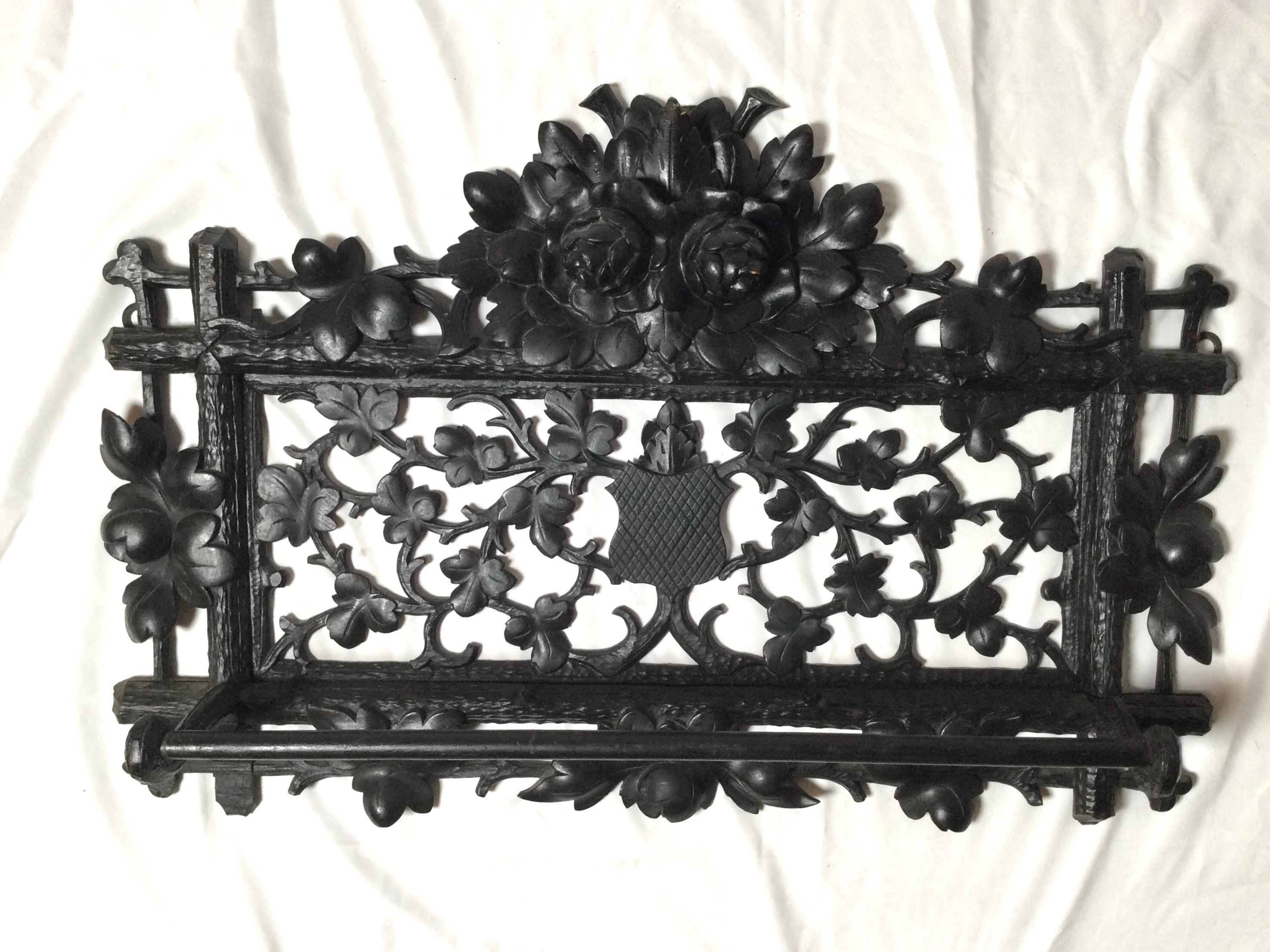 Beautifully carved black Forrest towel rack with hand carved and pierced back plate. The typical classic design with leaves, vines and center sheild.