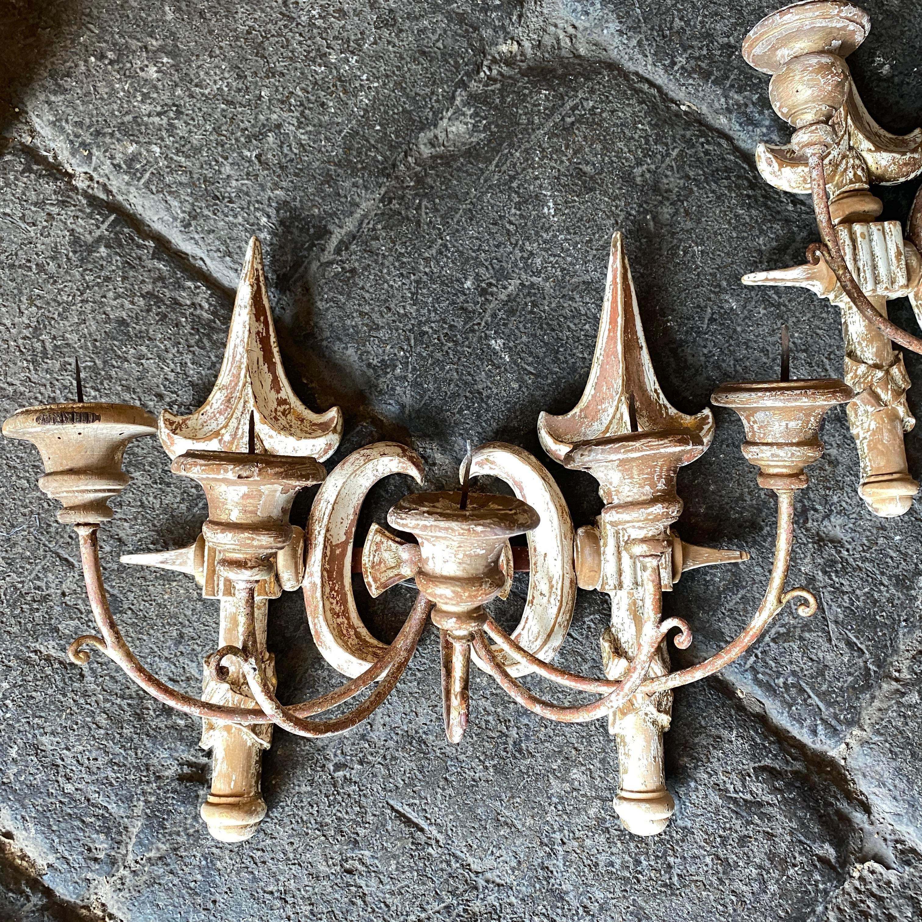 A pair of gilded and lacquered wood wall candelabra hand-crafted in Tuscany in late 19th century. They are in original conditions, the back part has been recently reinforced.