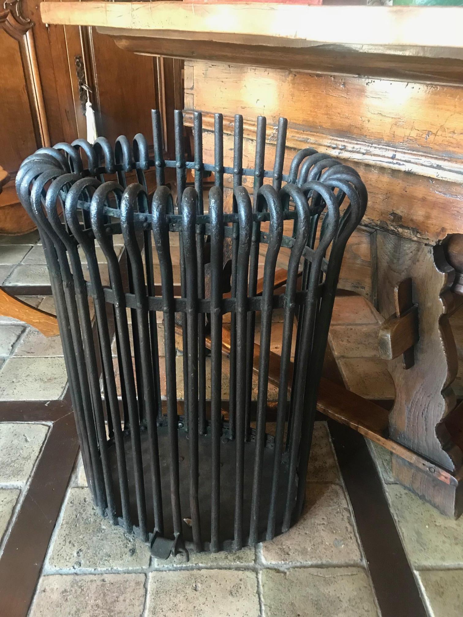 Late 19th century hand forged decorative metal elements as umbrella stand.
We have two of them available, they can be sold separately. could be used a log rack carrier holder 
These pieces were used originally for to transport the charcoal to heat
