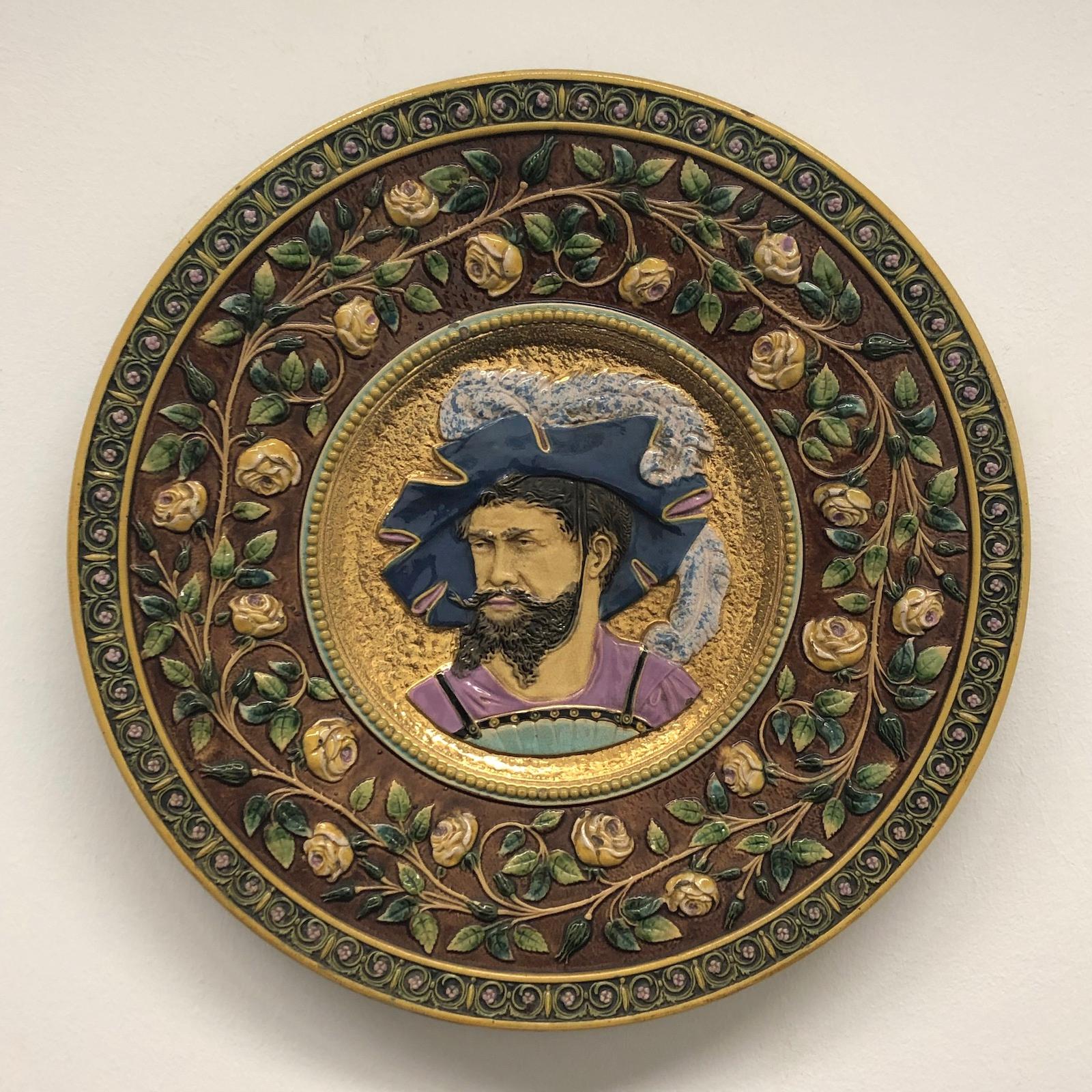 A large german majolica plate, circa 1880-1890s. The plate represent a german nobleman on a gold plated background surrounded by flowers.
Made by an unknown artist, it is not signed. With signs of wear as expected with age and use. 2 small chips