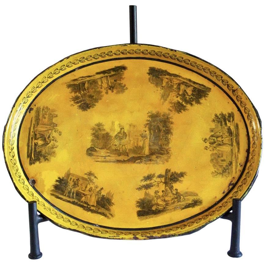 1810s French country yellow tole tray with a toile motif depicting scenes of the French countryside.  Tole is a type of tinplate domestic ware that has been enabled, lacquered, or painted. Sunny and inviting, this lovely piece features soft black