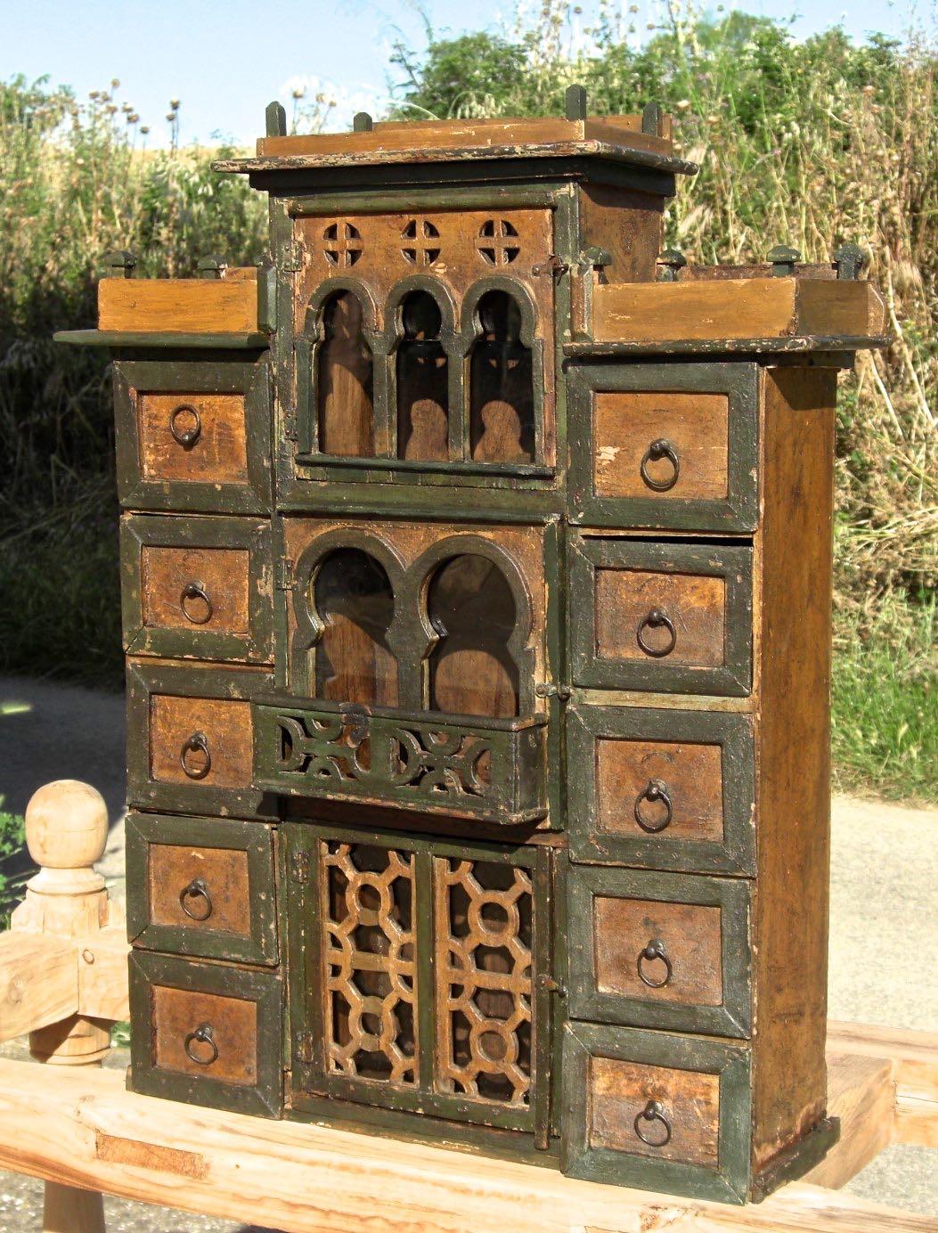 A whimsical late 19th century hanging Neo-Moorish spice cabinet from Granada, Spain.

Featuring 10 drawers and 3 doors, this 