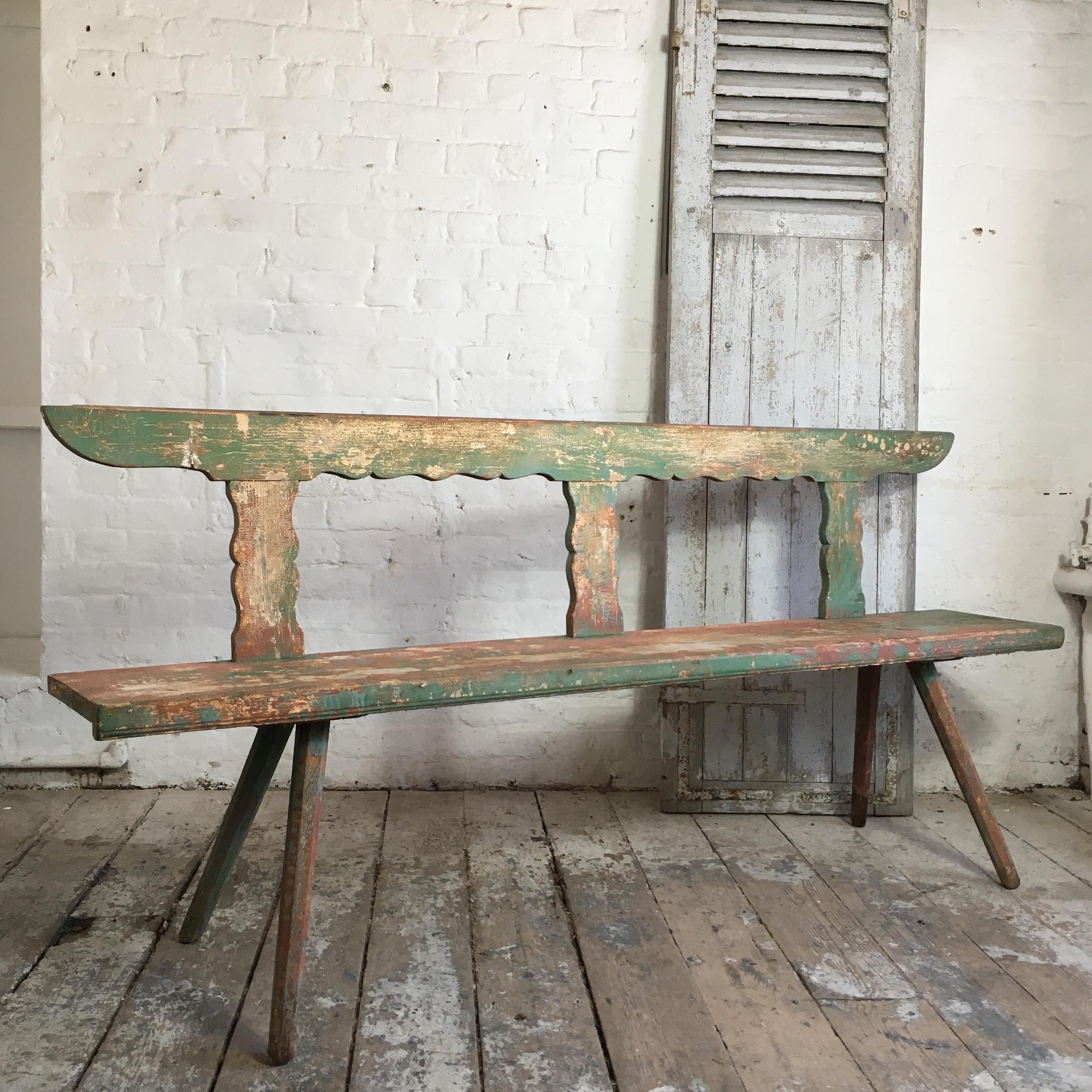 Late 19th century Hungarian bench. 

Handcrafted antique bench with original paint, the paint shows mixed colours and has a fantastic crackle and aged patina through years of use and wear. 

Measures: 191.5cm length, 87.5cm height, 46cm depth,