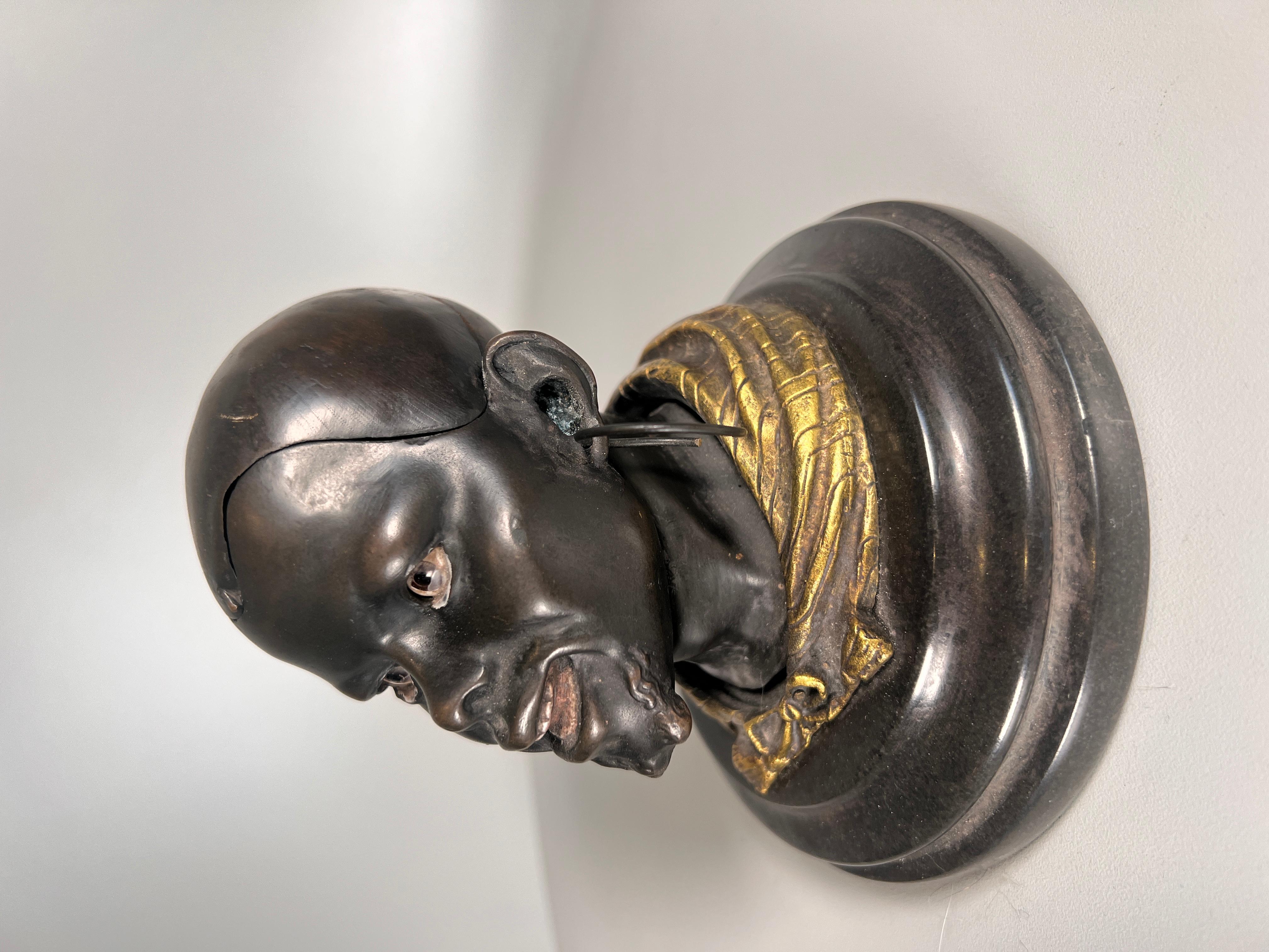 A Wonderfull quality bronze inkwell depicting a black African man, made by the goldscheider factory in Vienna around 1890, with inset glass eyes.