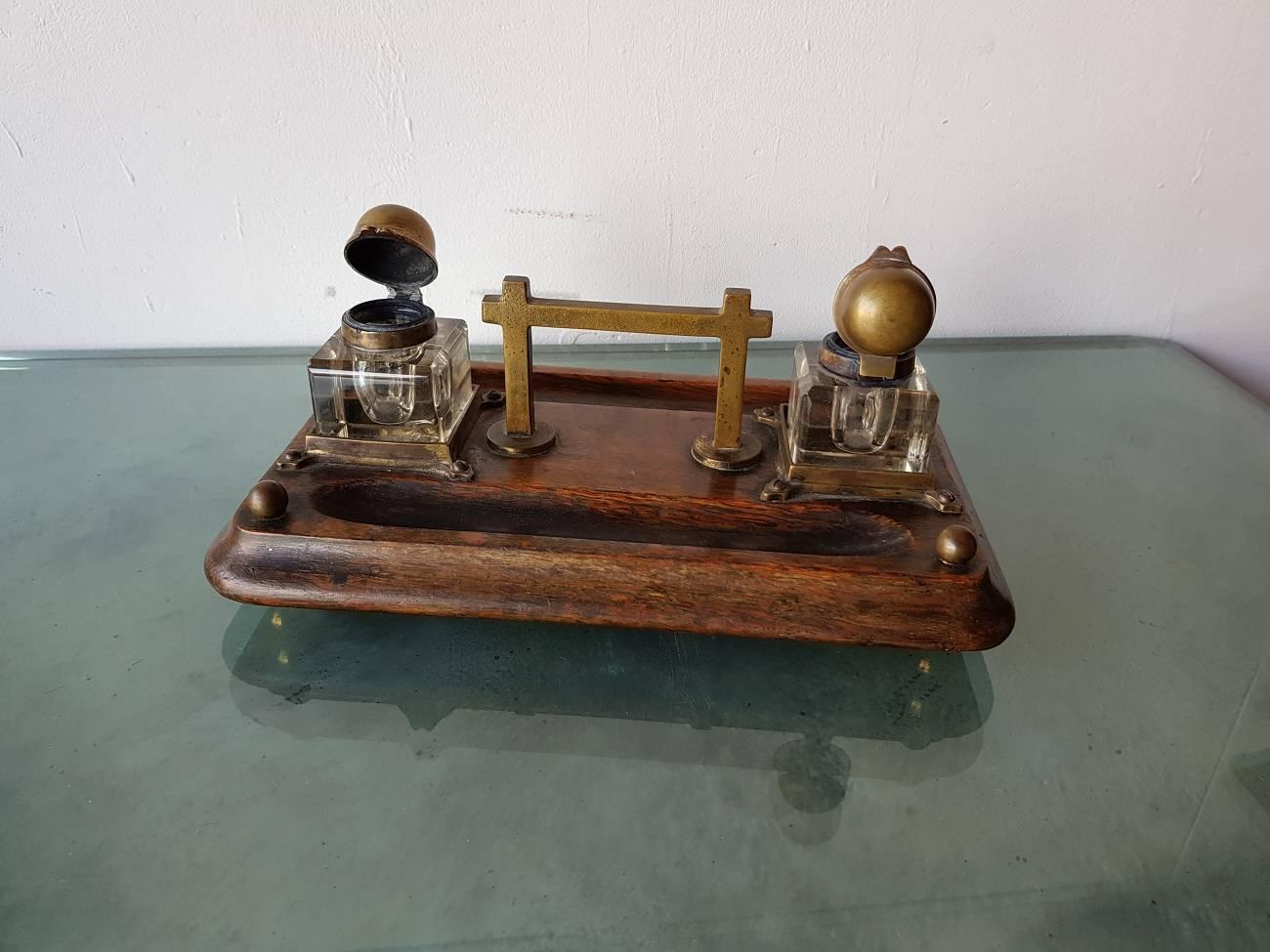 Lovely designed 19th century wooden inkstand or inkwell with glass ink pots and decorated with bronze elemants.

The measurements are:
Depth 17 cm/ 6.6 inch.
Width 28 cm/ 11 inch.
Height 10 cm/ 3.9 inch.
 