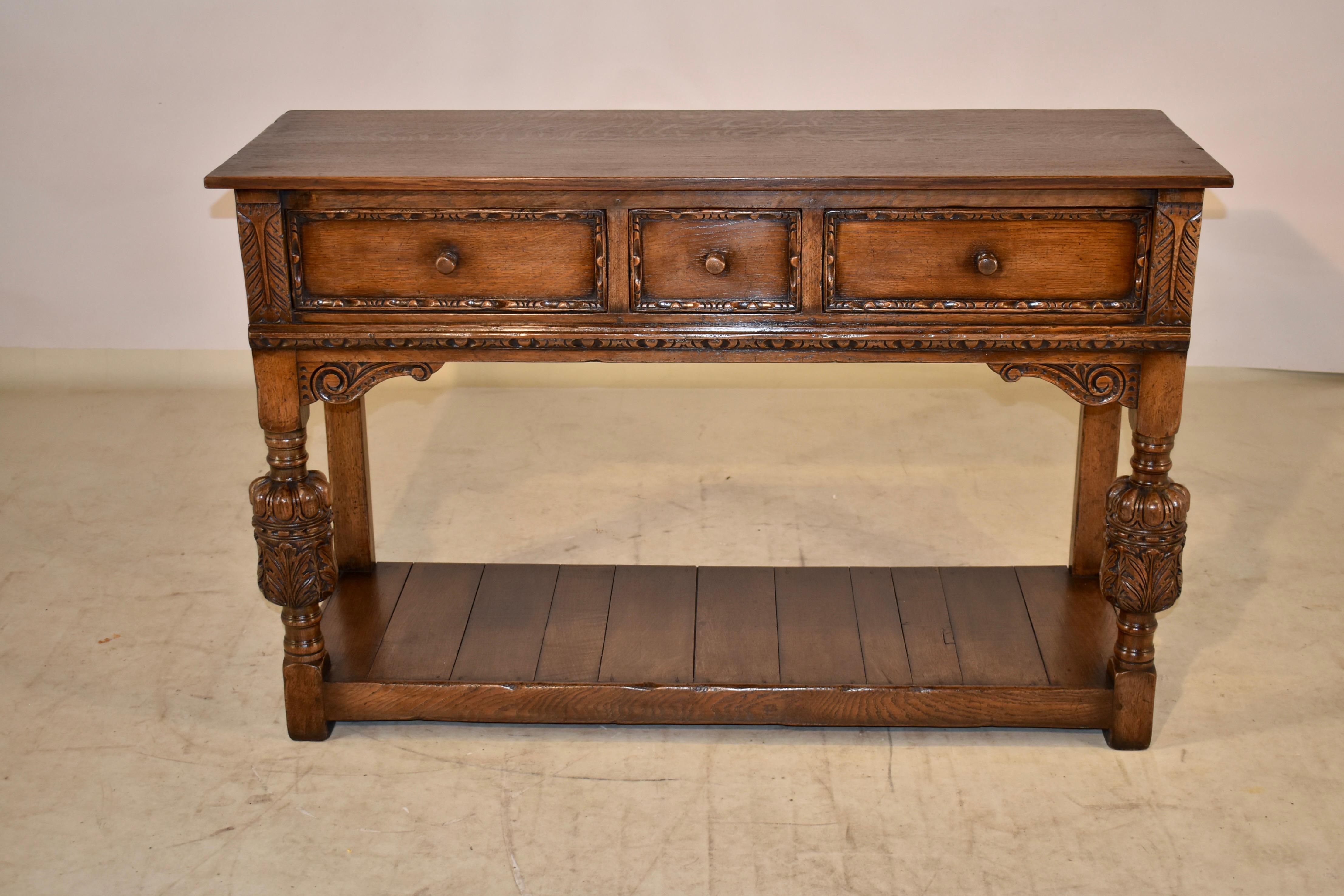 Late 19th century Ipswich oak pot board from England. The top is made from two boards, and follows down to paneled sides and three drawers in the front. The drawer fronts are all carved molded for added depth and design detail. The piece is