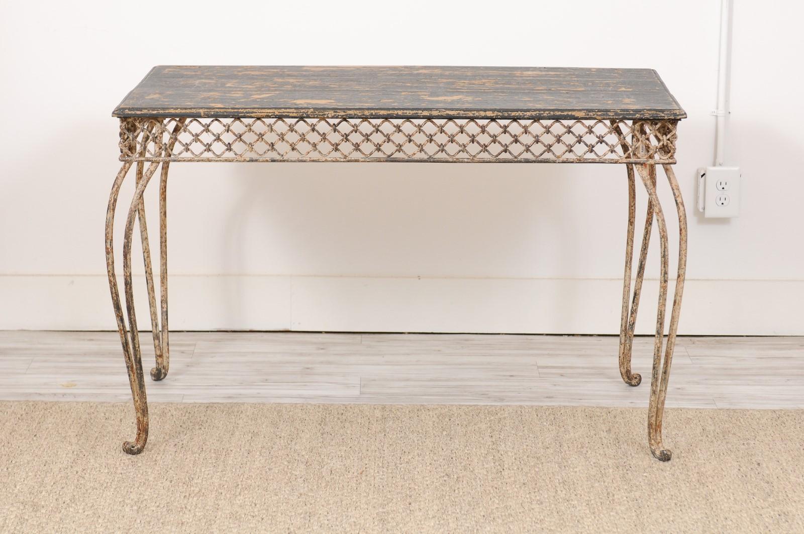 Why we love it, it's an elegant iron and wood garden table with intricate detailing, a pretty patina and superb crunch.