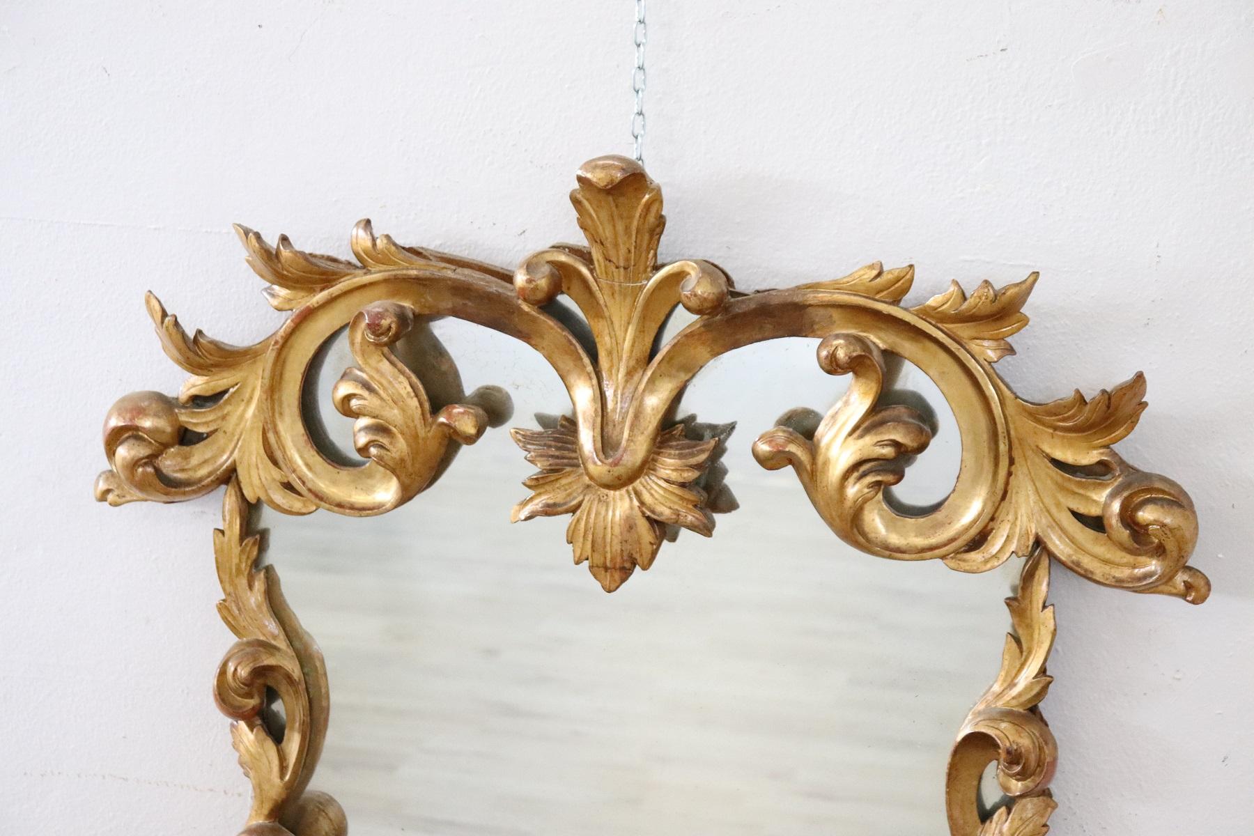 Beautiful elegant wall mirror in perfect Baroque style, 1880s wood hand carved with finely and richly swirls and curls . Refinement decorated in gold leaf. In good antique conditions.
