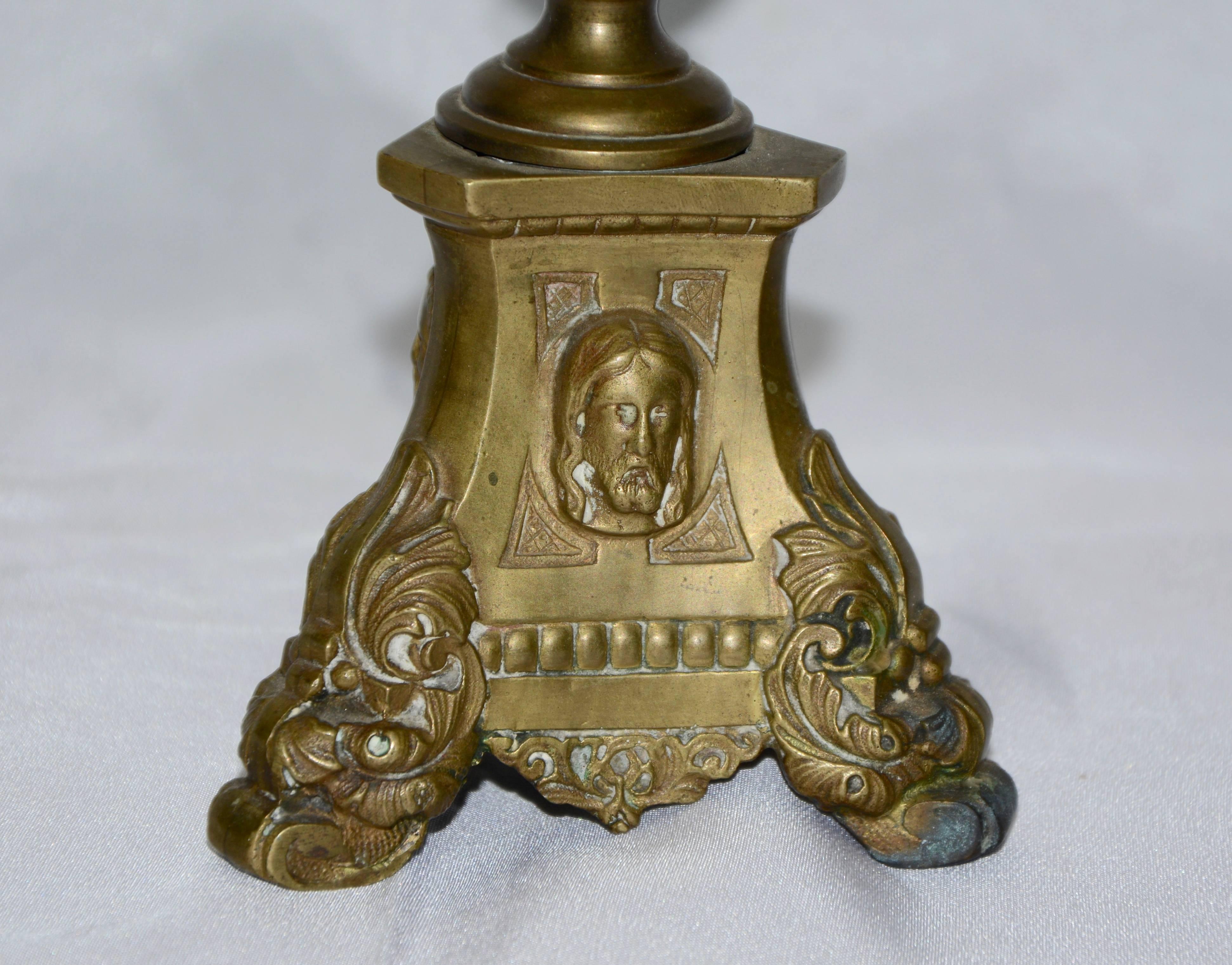 Heavy, solid cast brass forms this brass altar oil burner from Italy. Three different figures are on each side of the triangular base. The underside of the base is marked XII.