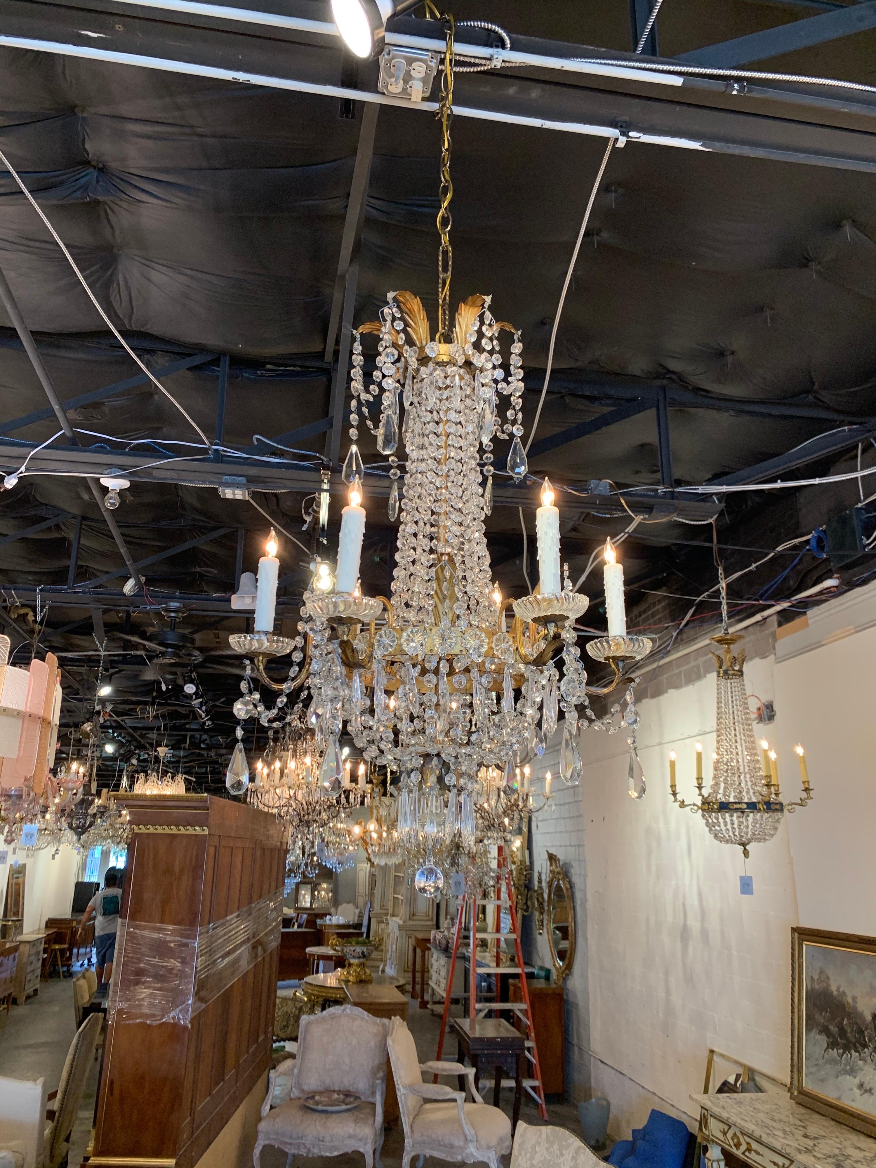 Exquisite late 19th century Italian Empire style crystal chandelier with 6 lights. Covered in beautiful cut crystals. Nice details on the base including leaves at the top and on the arms. Makes a very elegant statement!