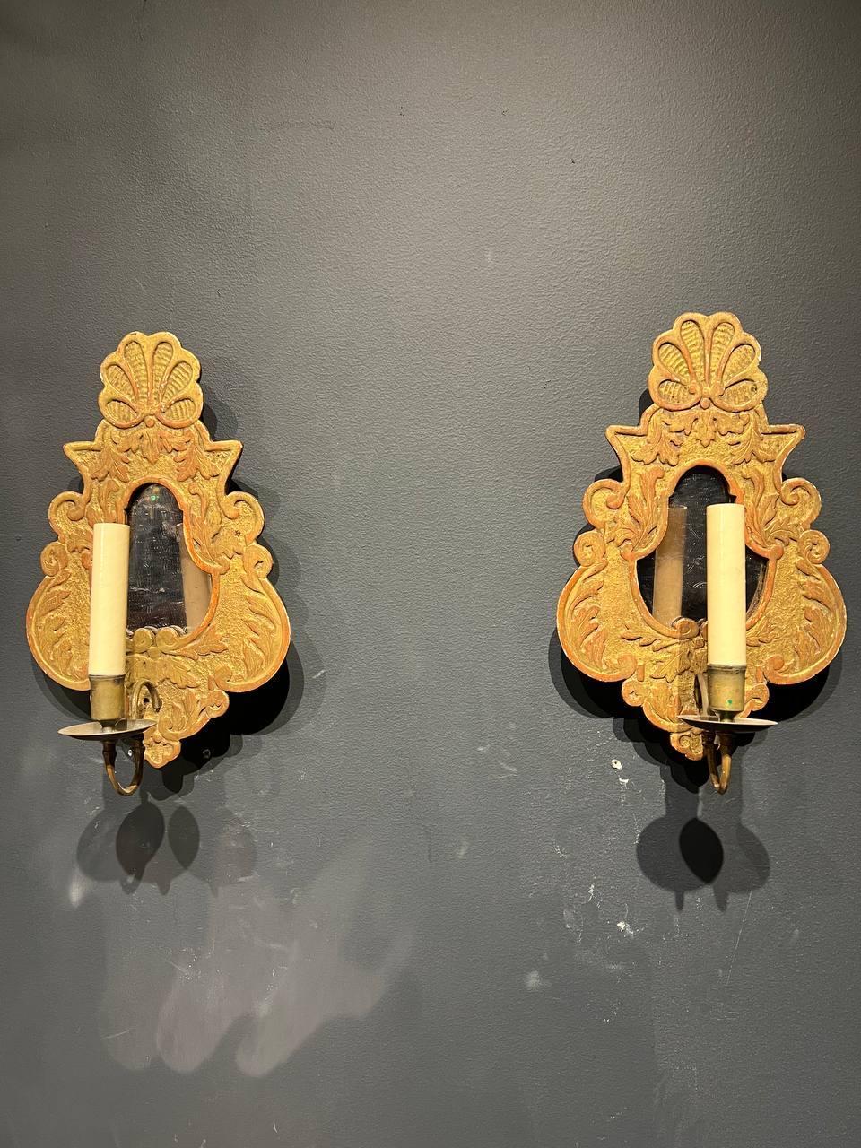 A set of late 19th century Italian giltwood one light sconces with mirror center.
