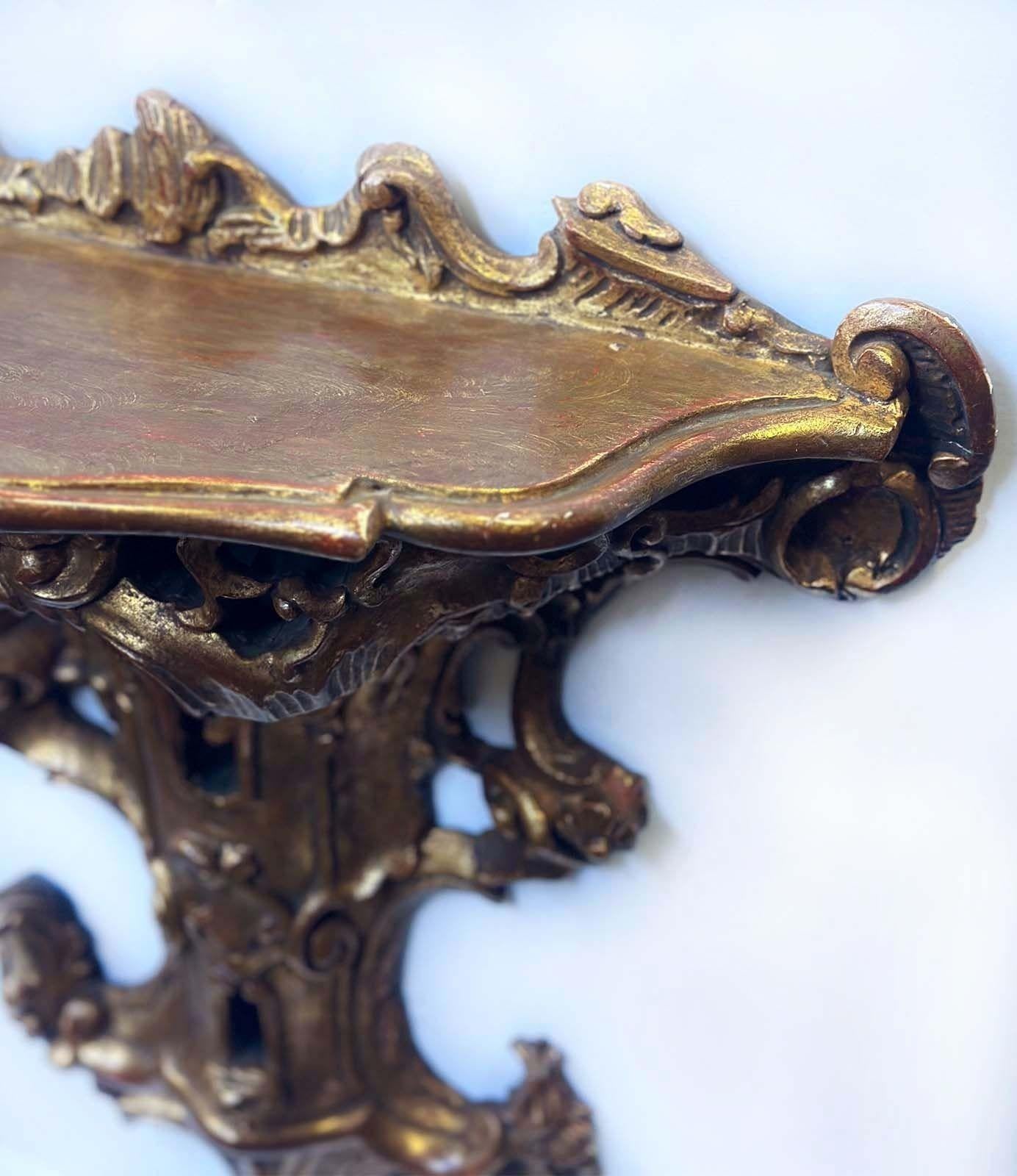 Beautiful Late 19th Century Italian hand carved gilt wood brackets each having an open shelve and adorned with foliate scrolls motifs all around.