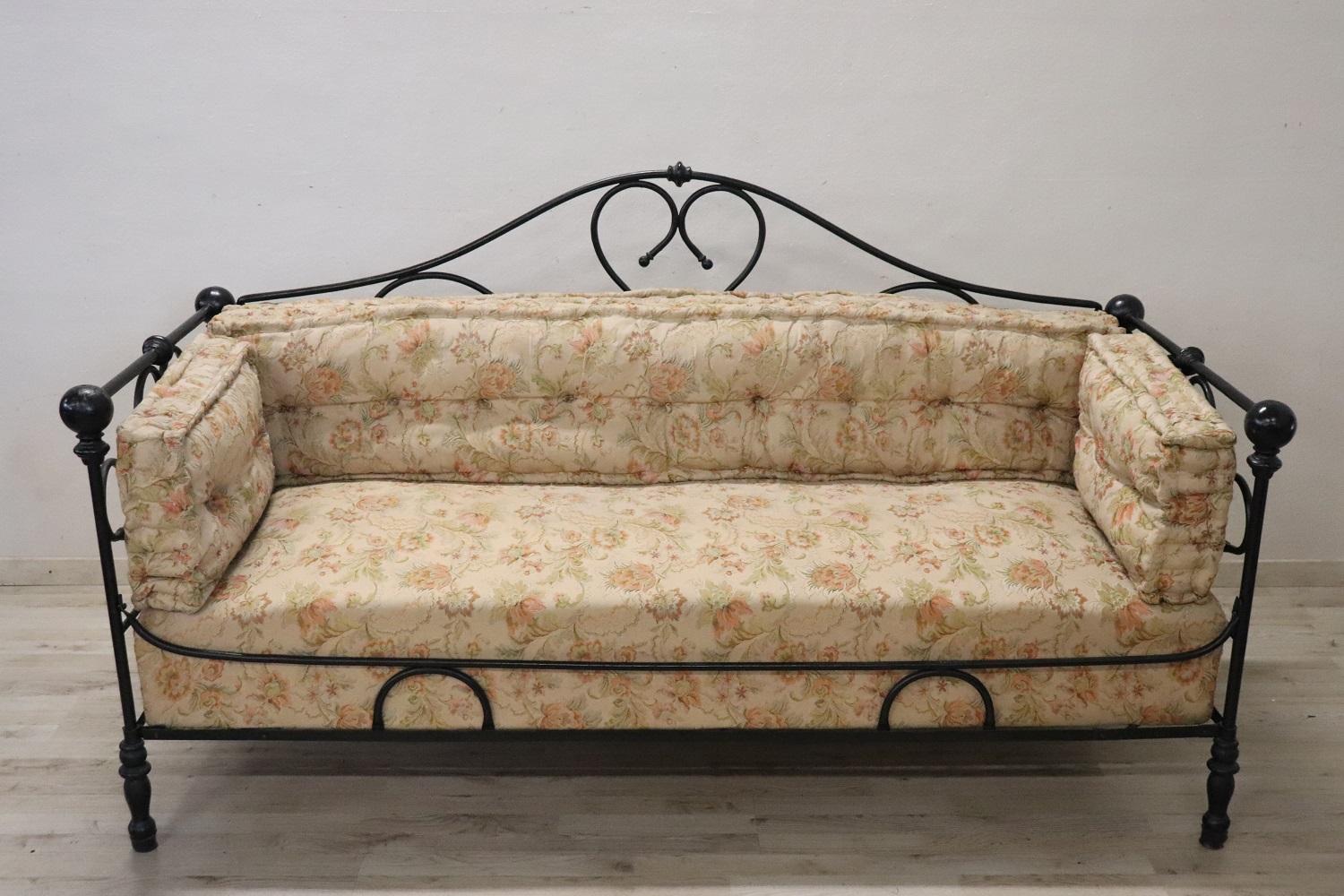 Rare italian antique large settee, late 19th century. The settee is made of solid iron. The iron has a refined and elaborate decoration with curls and scrolls. The decoration is present on each side so it is possible to place the settee also in the