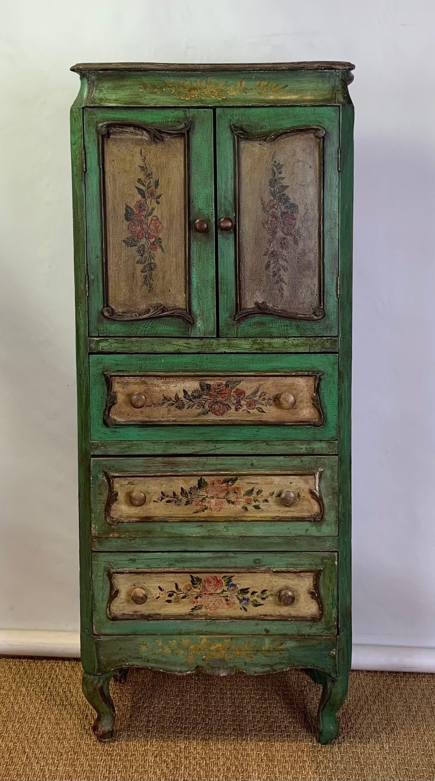 A colorfully painted and decorated late 19th century Italian semanier or lingerie cabinet having two cabinet doors above three drawers resting on cabriole legs.