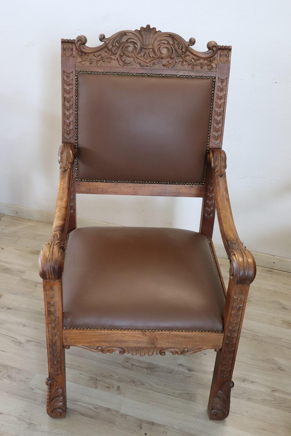 Impressive rare pair of throne chairs in perfect Italian Renaissance style, late 19th century. Made of solid walnut wood. The finely carved wooden backrest with very complex decoration. Note how the decoration carved in the wood is also present on