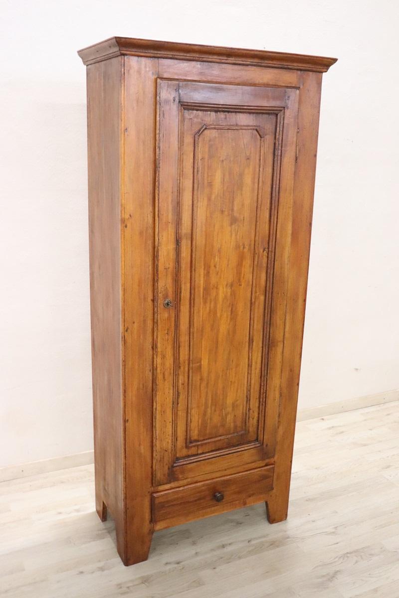 Introducing a charming small cabinet crafted from solid poplar wood, dating back to the late 19th century. With its compact dimensions and single front door, this piece is incredibly versatile, making it an ideal addition to even the smallest of