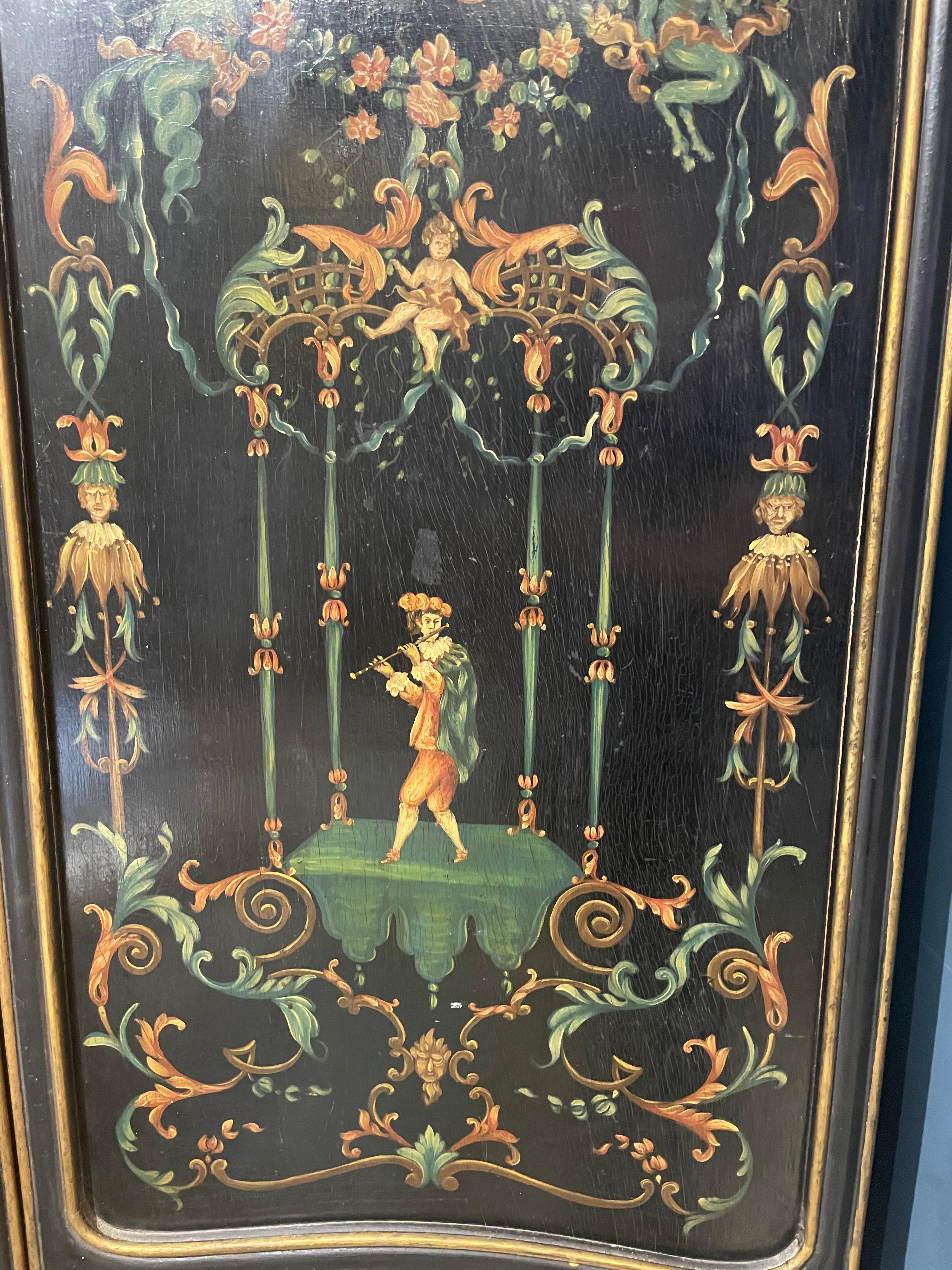 Four screen rectangular paravent. The panels are painted on wood . The upper part is in the shape of a gendarme’s hat.
Each panel is richly painted with floral decor, galantes, costumed characters, babys and mythological characters. The abundant