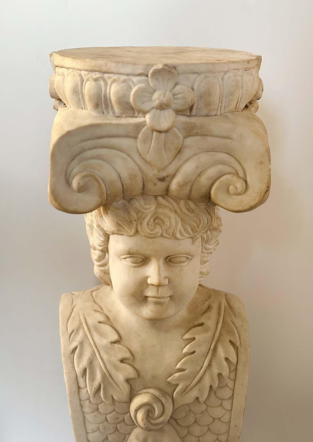Palatial Late 19th Century Italian white marble pedestal featuring a figural column adorned with botanical and grapevine depictions. Topping off the pedestal is a round-shaped surface, providing a perfect platform for displaying art, sculptures, or
