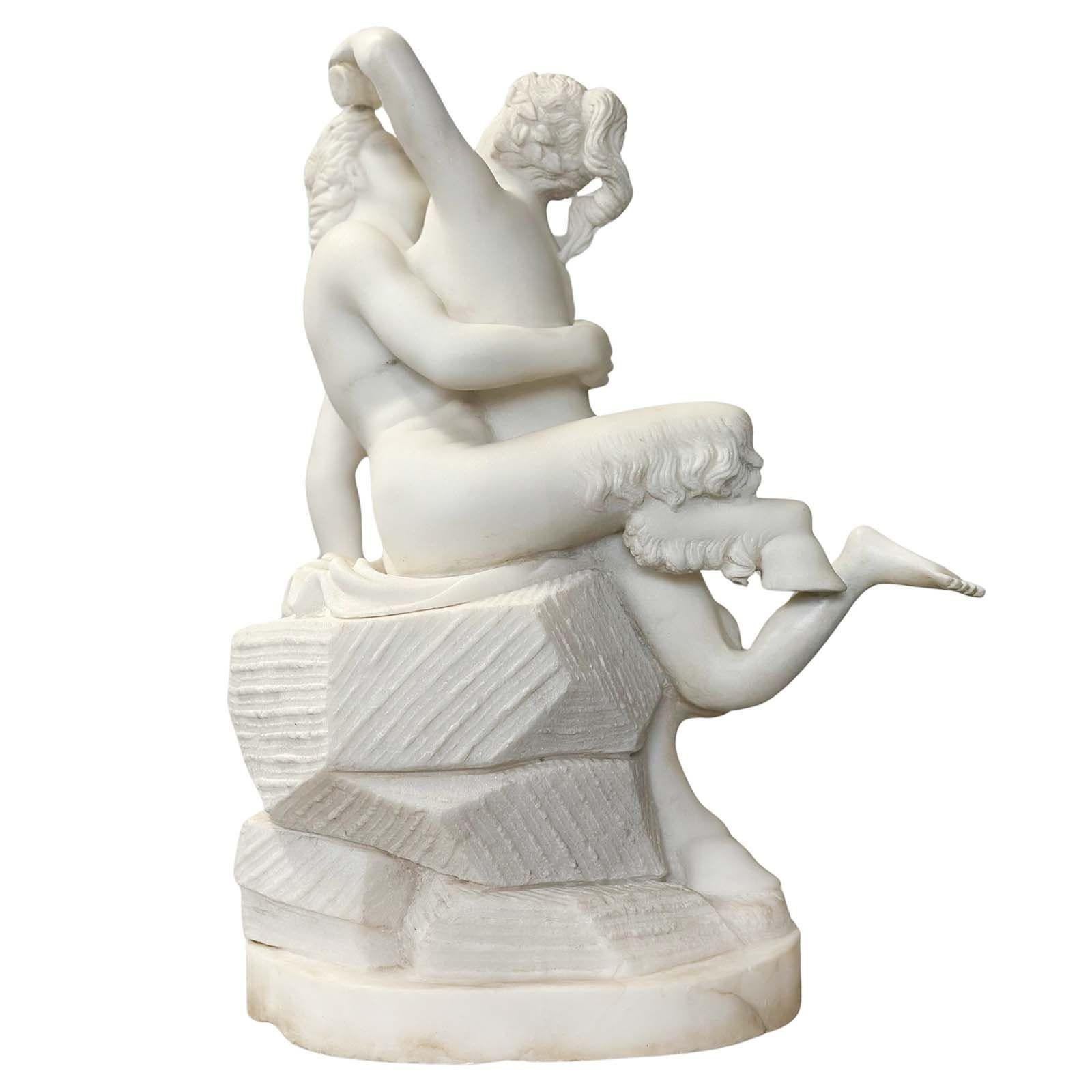 Alluring white marble sculpture made in Italy in the late 19th Century, depicting a beautiful nude woman giving water to a centaur, while he's holding her in his arms. They are sitting on rocks and the piece is supported by an oval