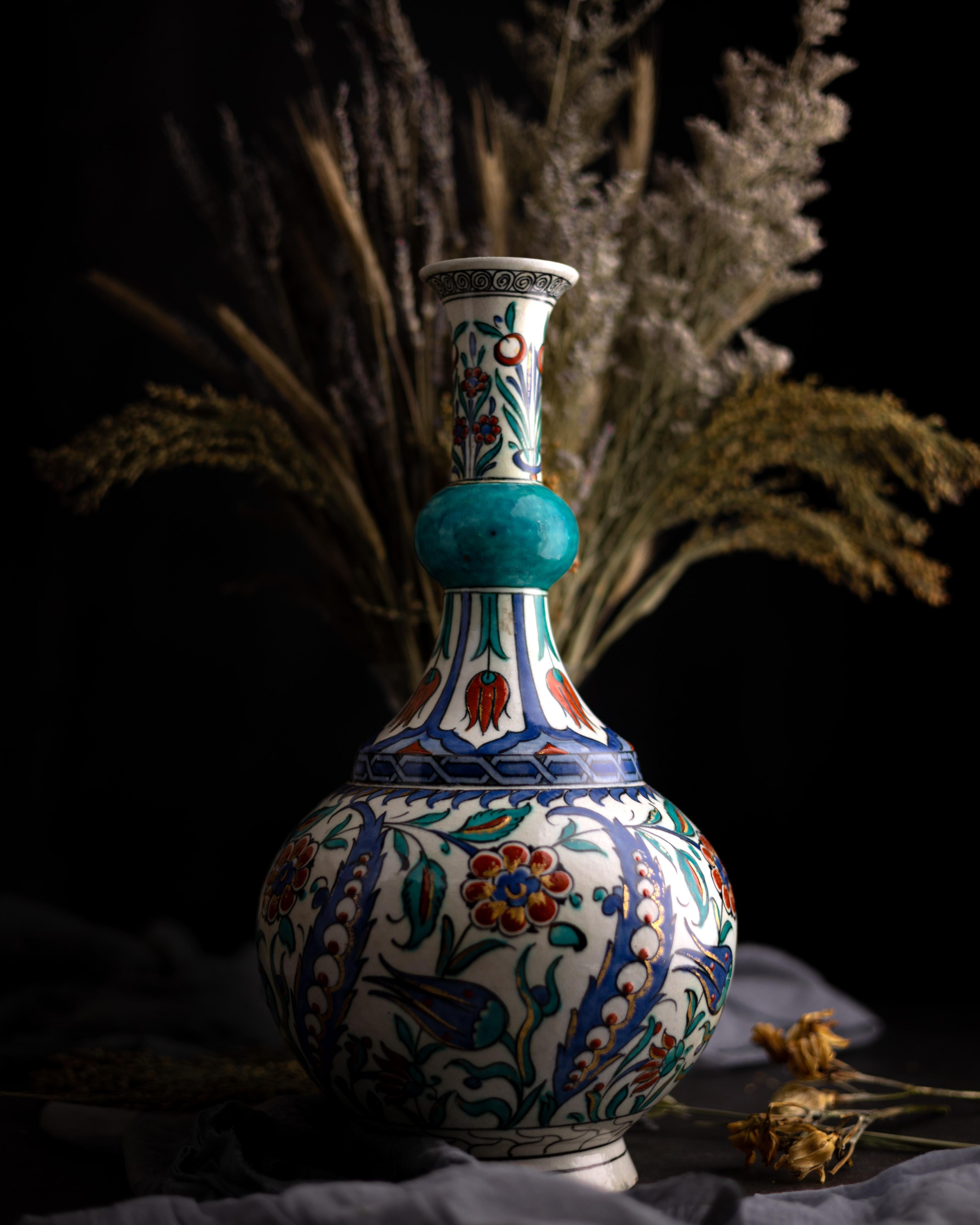 An Iznik-style vase made by Edmé Samson et Cie after a 16th-century Turkish bottle vase in the collection of the Musée d'Ecouen.

The vase’s bulbous body is decorated in a red, cobalt blue, turquoise, and green floral design of saz leaves, roses,