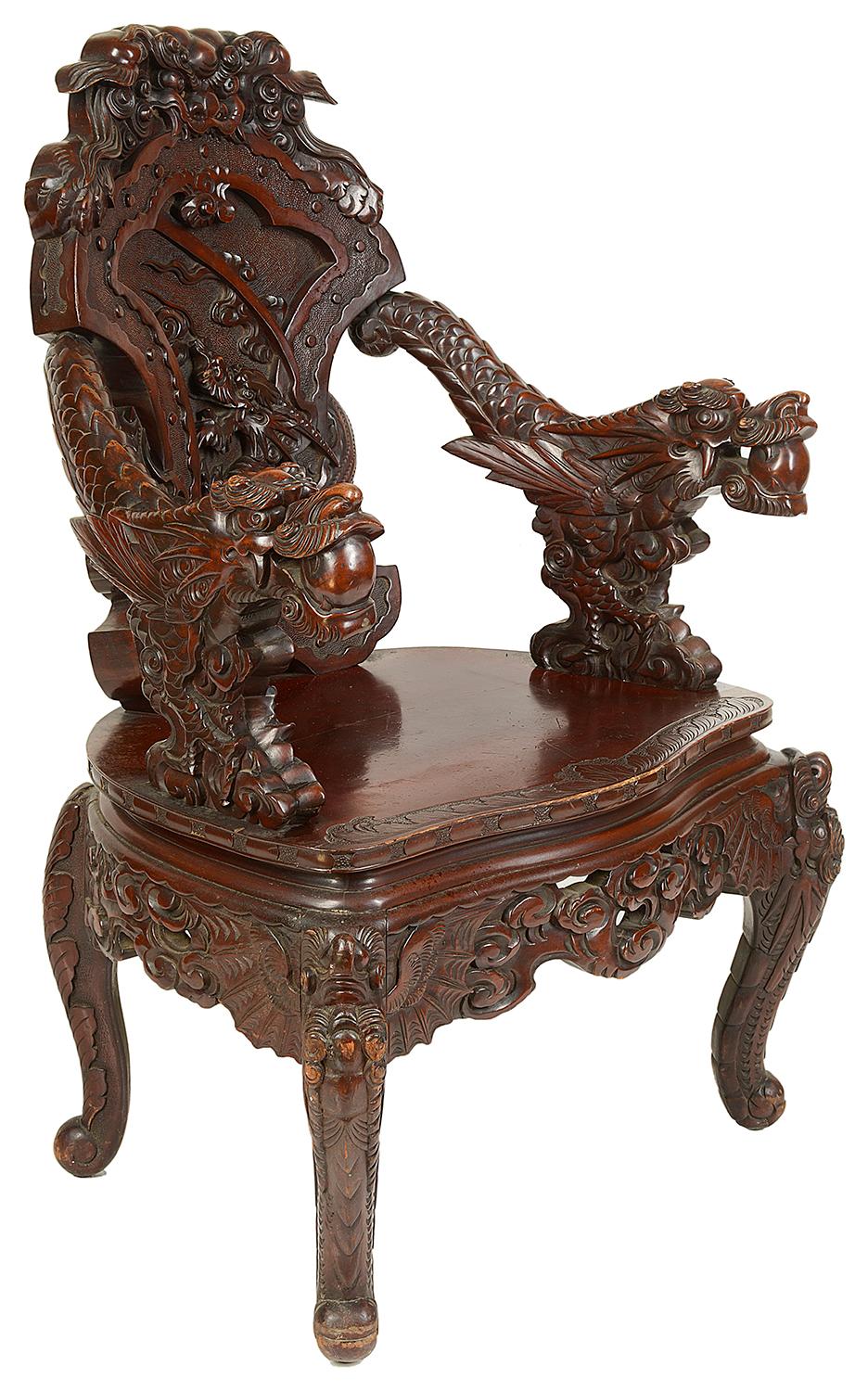 A very dramatic 19th century Japanese carved armchair. Depicting mythical dragons to the arms and back, amongst clouds. Raised on carved cabriole legs.