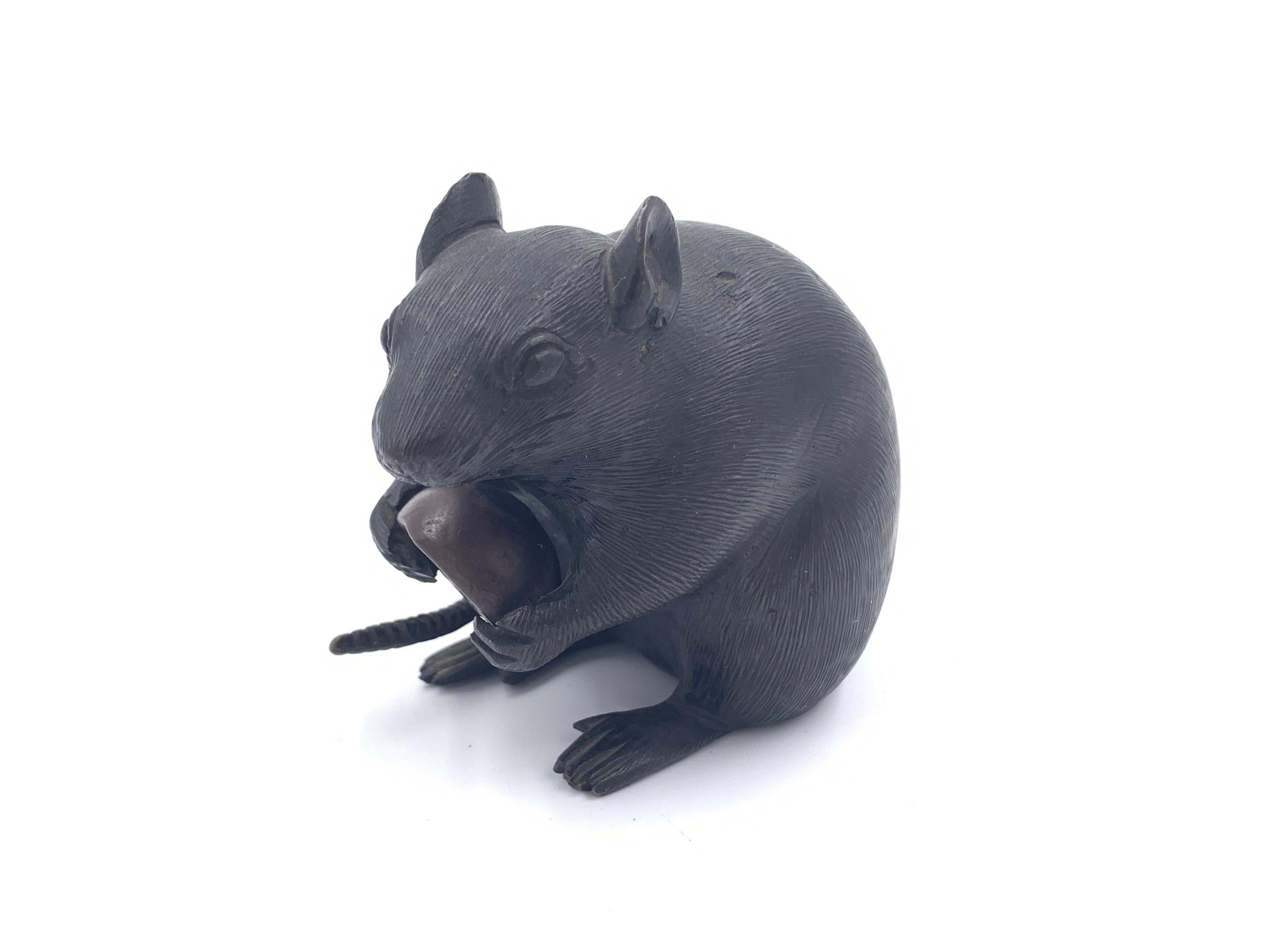 Japanese bronze Okimono of a rat clutching a chestnut, Meiji period signed on the base.
 