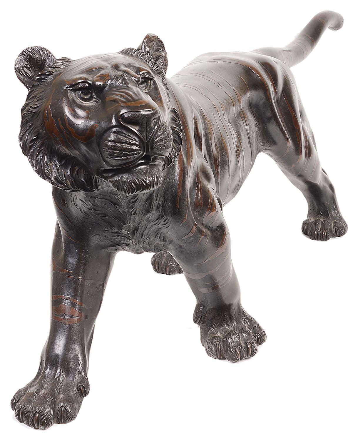 A very impressive late 19th century Japanese two-color bronze study of a tiger, signed underneath.